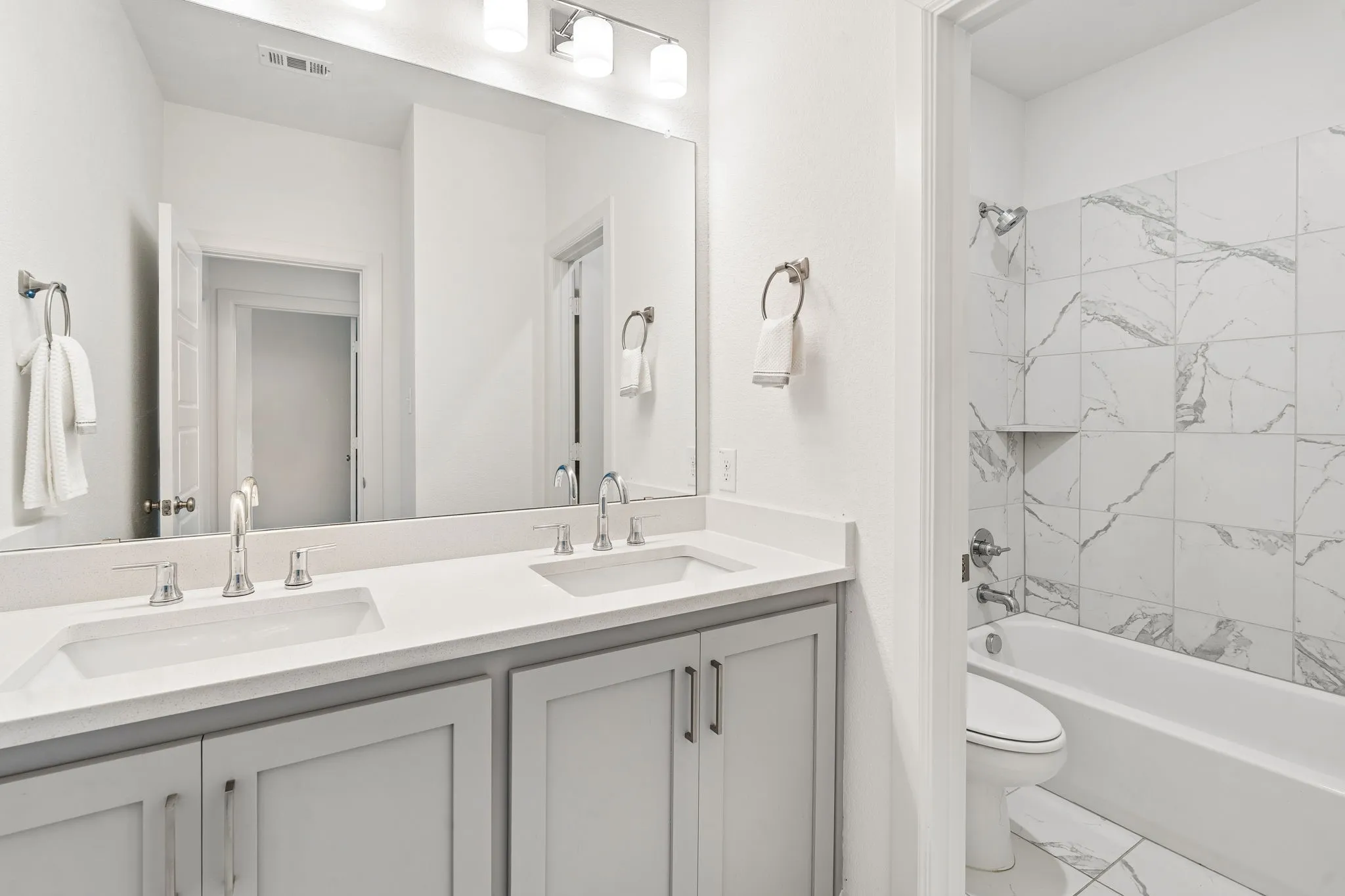 2nd floor bathroom with dual sinks and separate shower area
