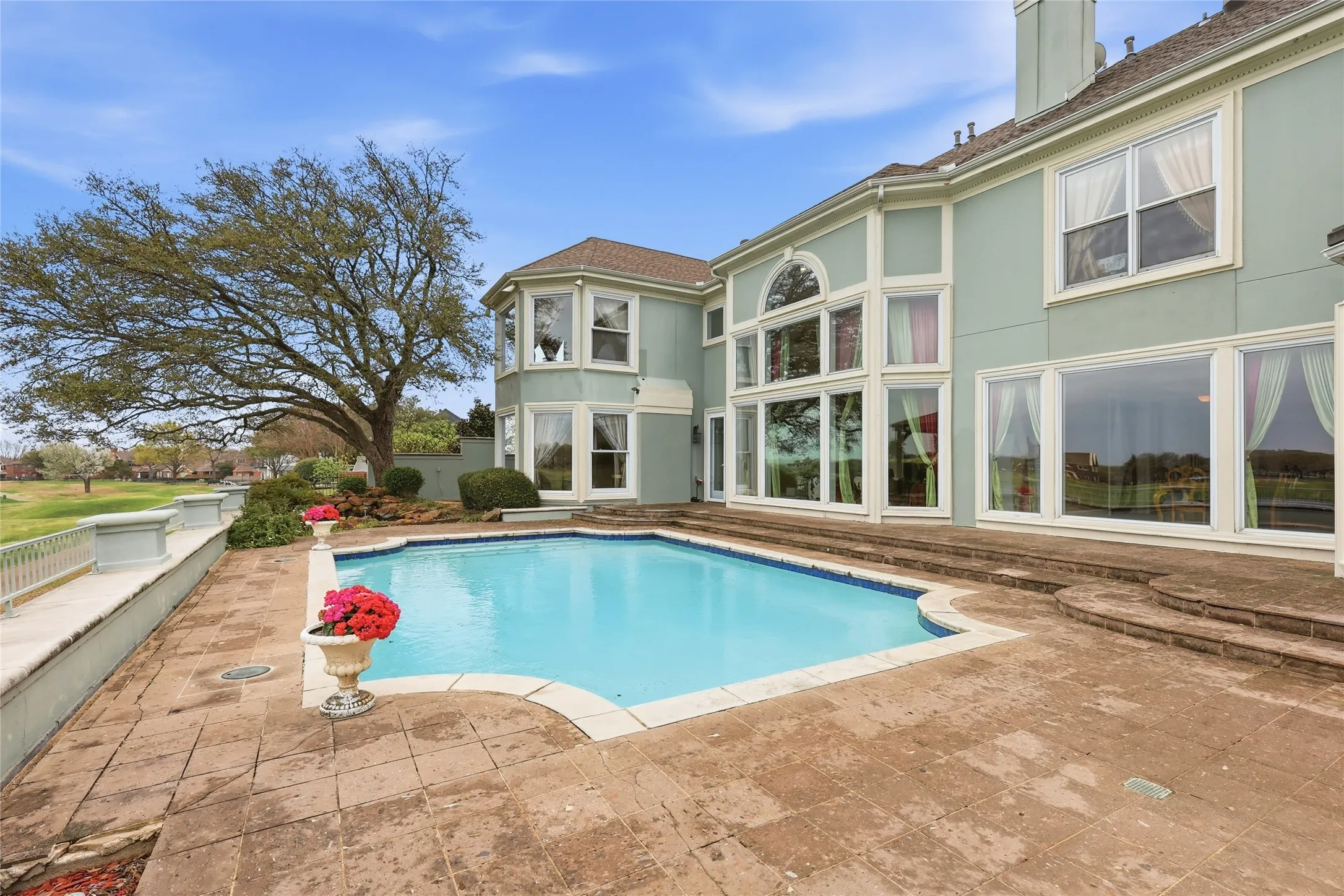 View of swimming pool featuring patio surround