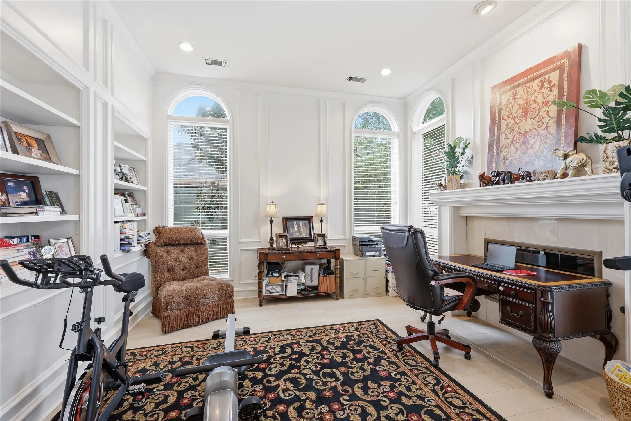 Office space with a decorative wall, built in features, recessed lighting, and ornamental molding
