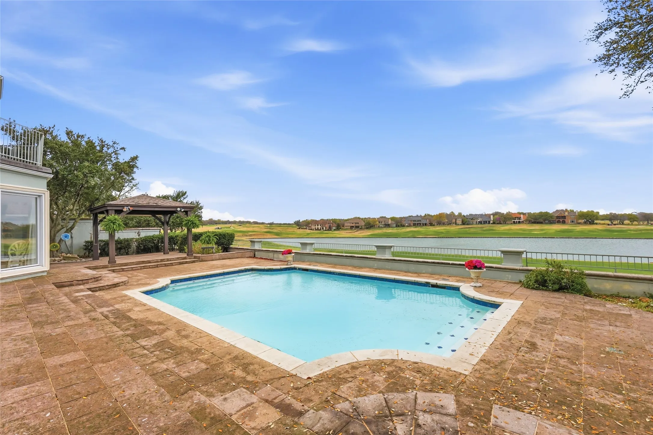 View of pool with a gazebo and patio surround