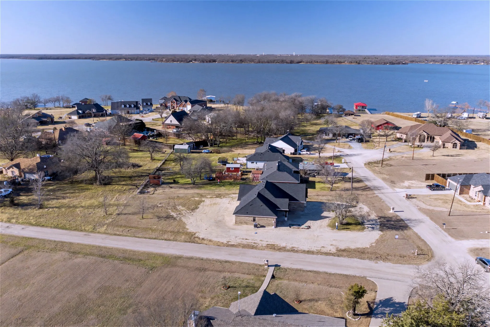 Aerial perspective of suburban area with a large body of water