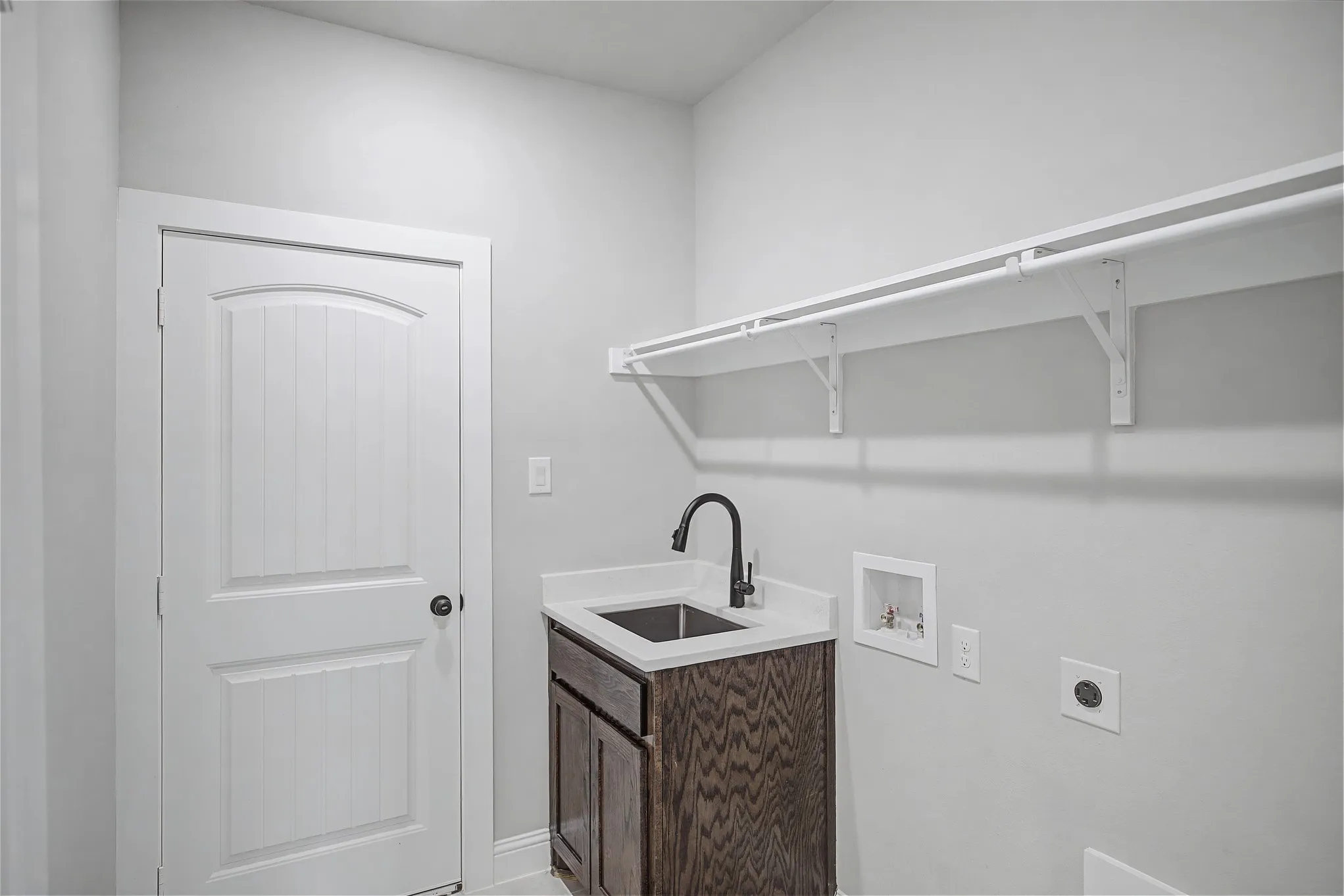 Laundry room with electric dryer hookup, washer hookup, and cabinet space