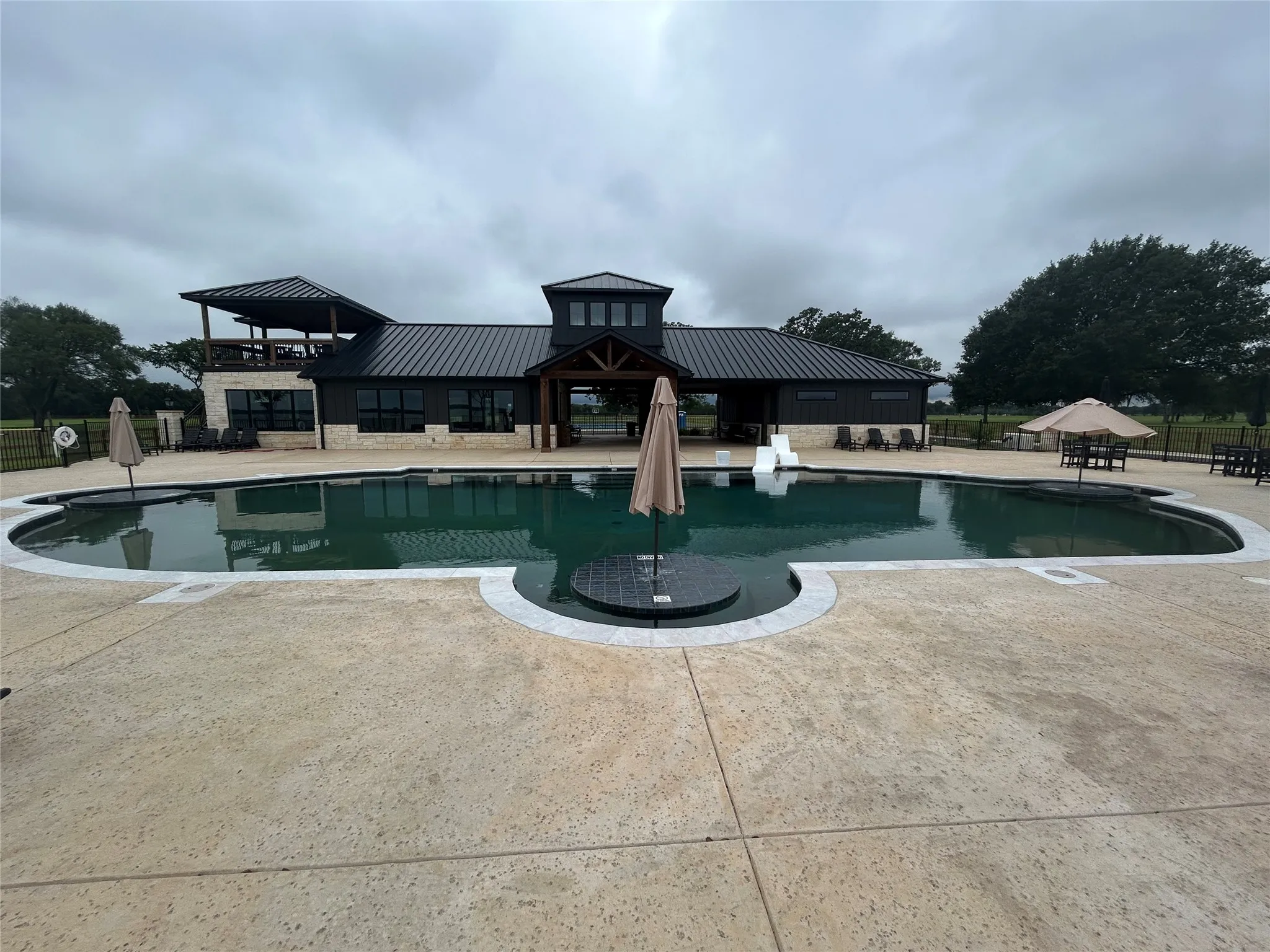 Expansive outdoor swimming pool with a textured concrete surround
