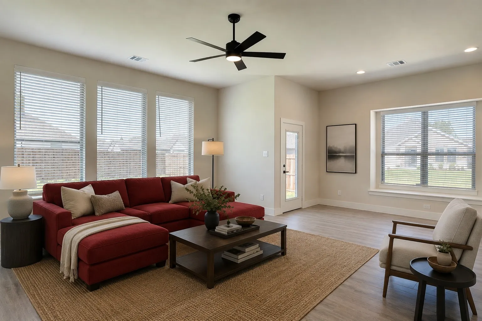 Virtually staged.
Spacious living area featuring wood-finish flooring, recessed lighting, and a modern ceiling fan