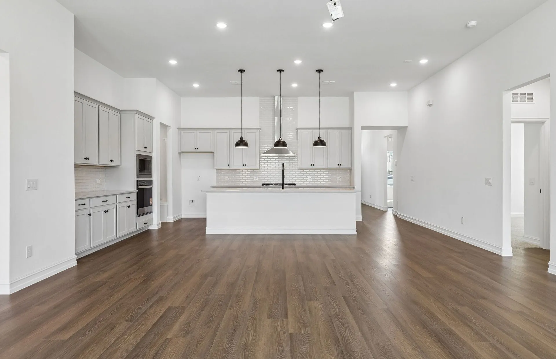 Spacious gathering room with view of kitchen