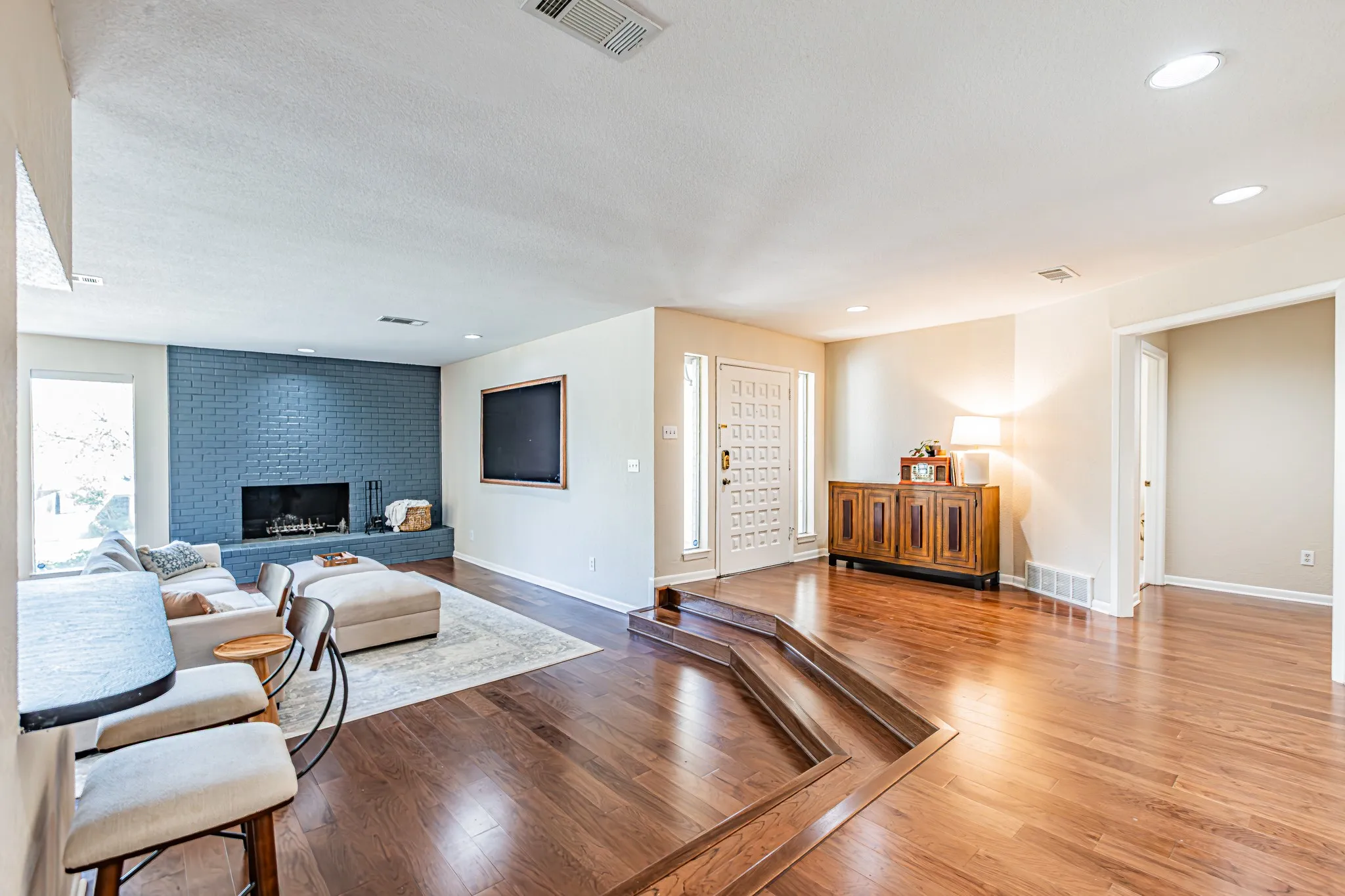 Wood burning fireplace. Framed TV conveys.