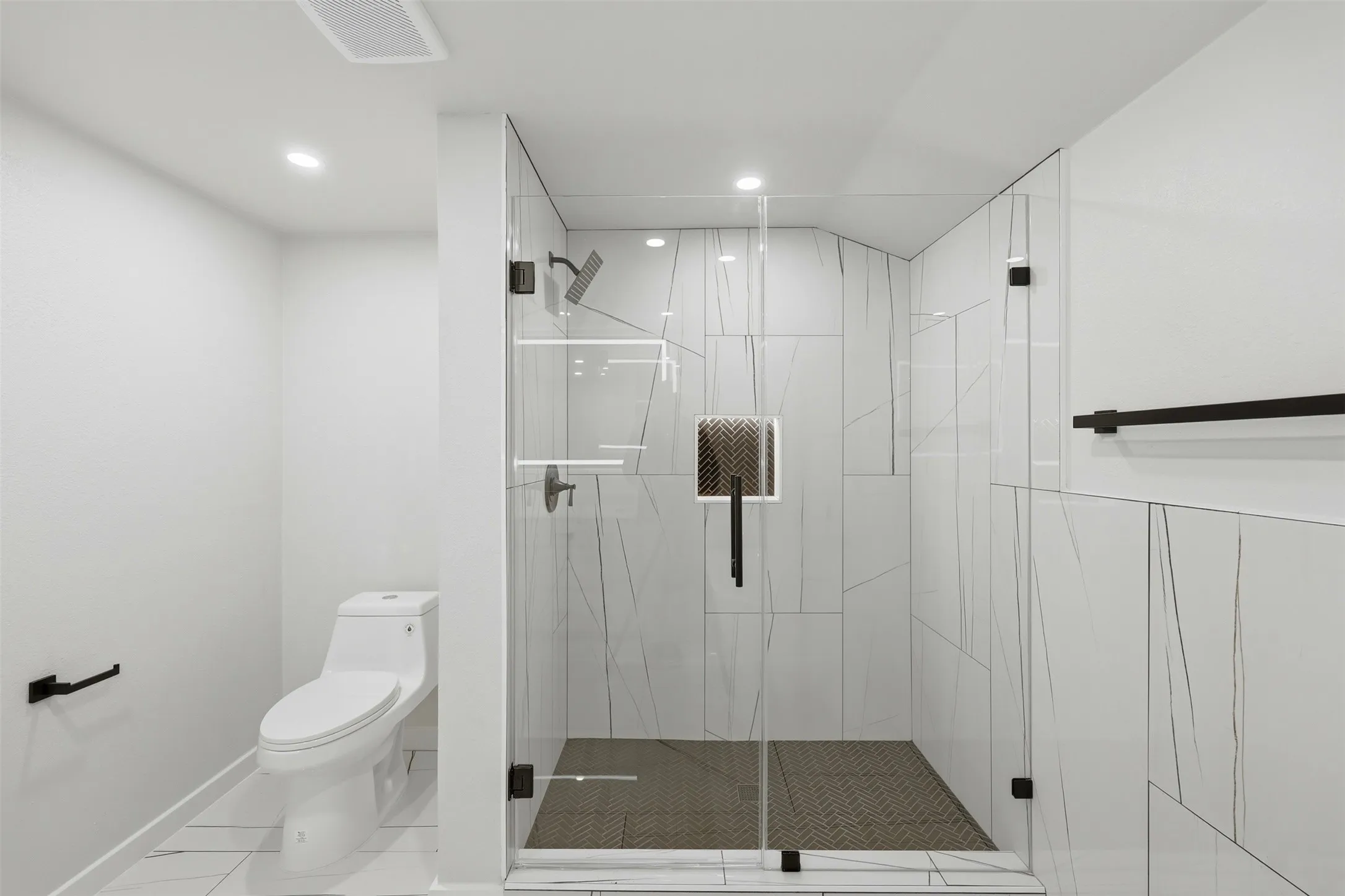 Spacious primary walk-in-shower.