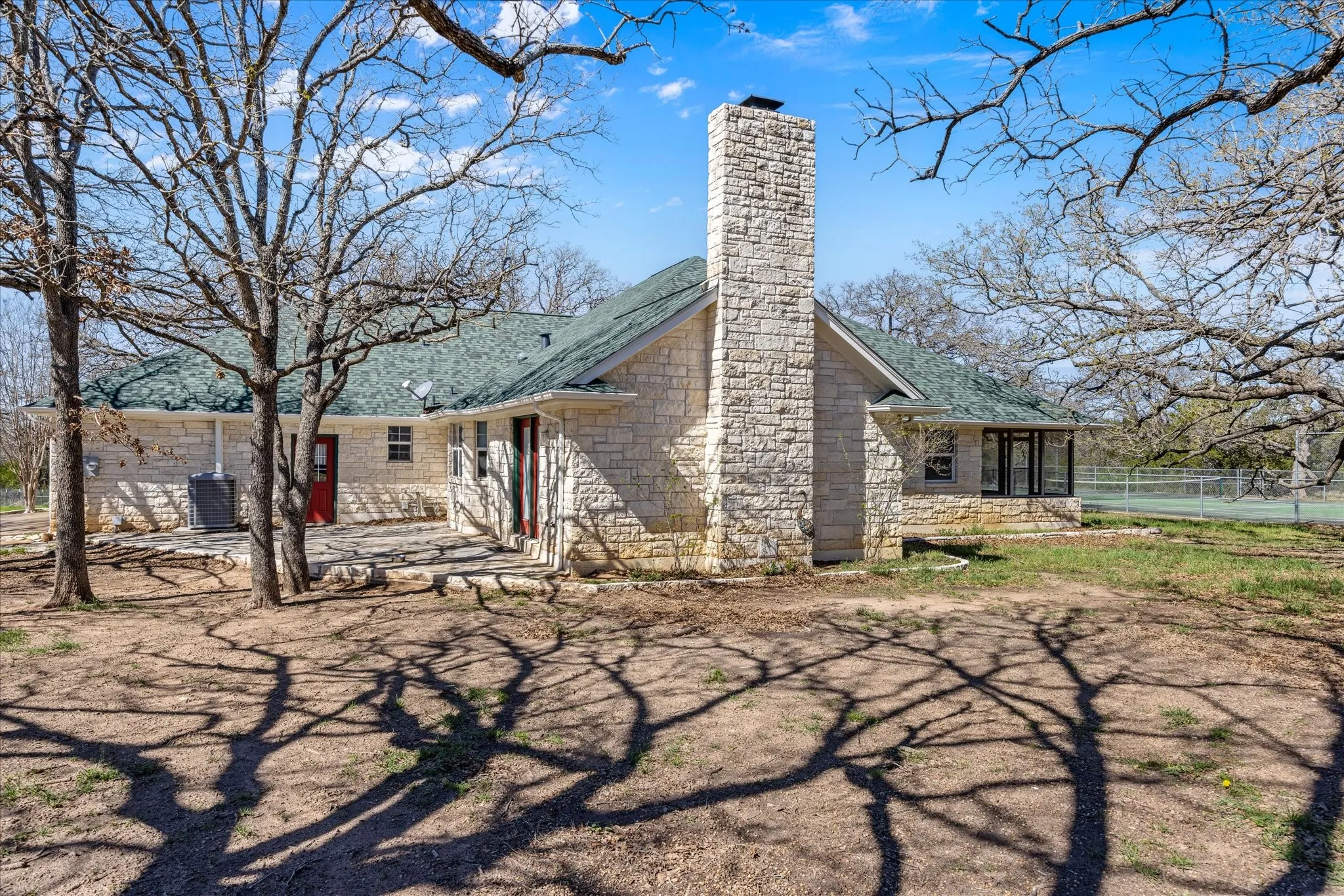Great view of the other fireplace, you can see the tennis courts out to the right.  Very easily would covert to a pickle ball court.