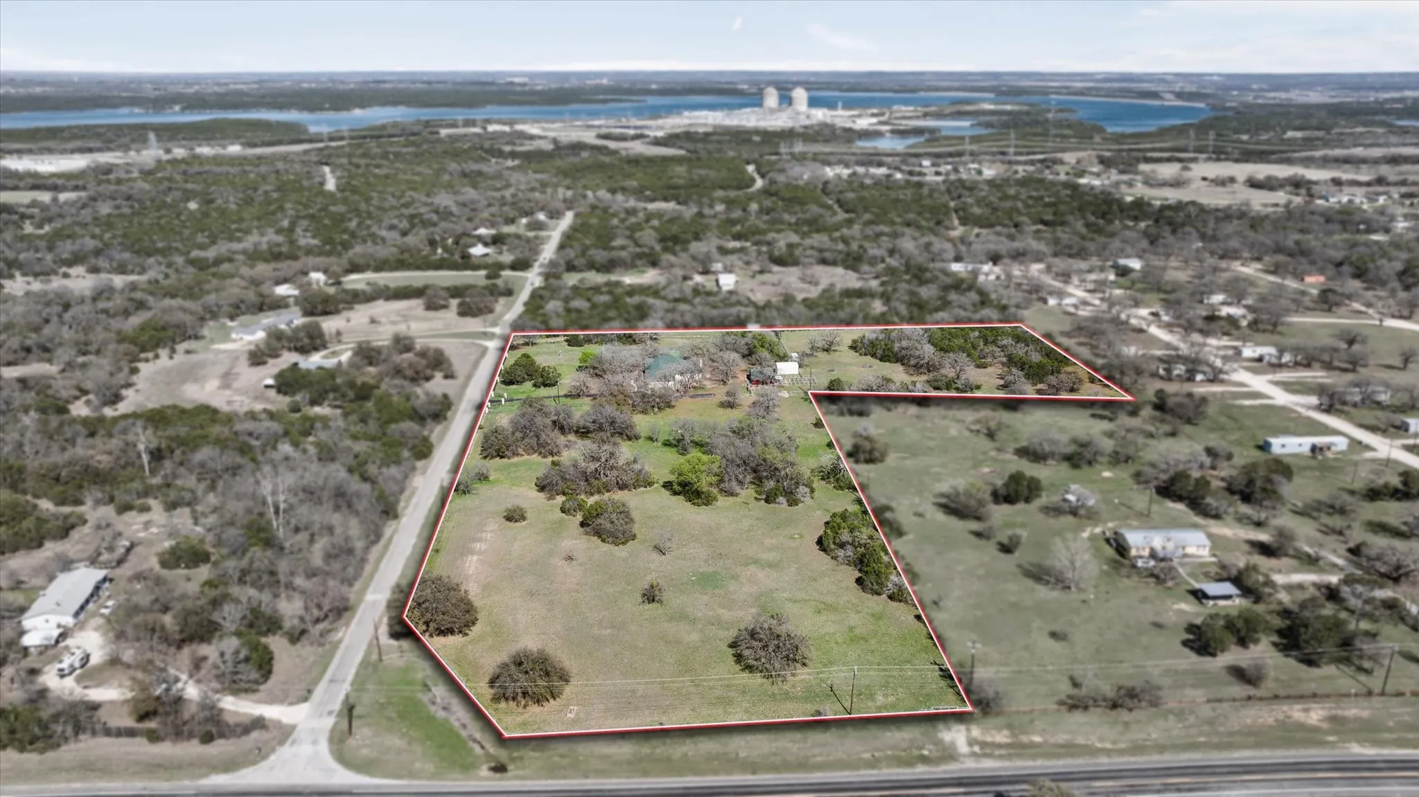 This aerial view shows that approximal this is 5 acres of land is Hwy frontage of Farm Road 51 leading into Glen Rose.