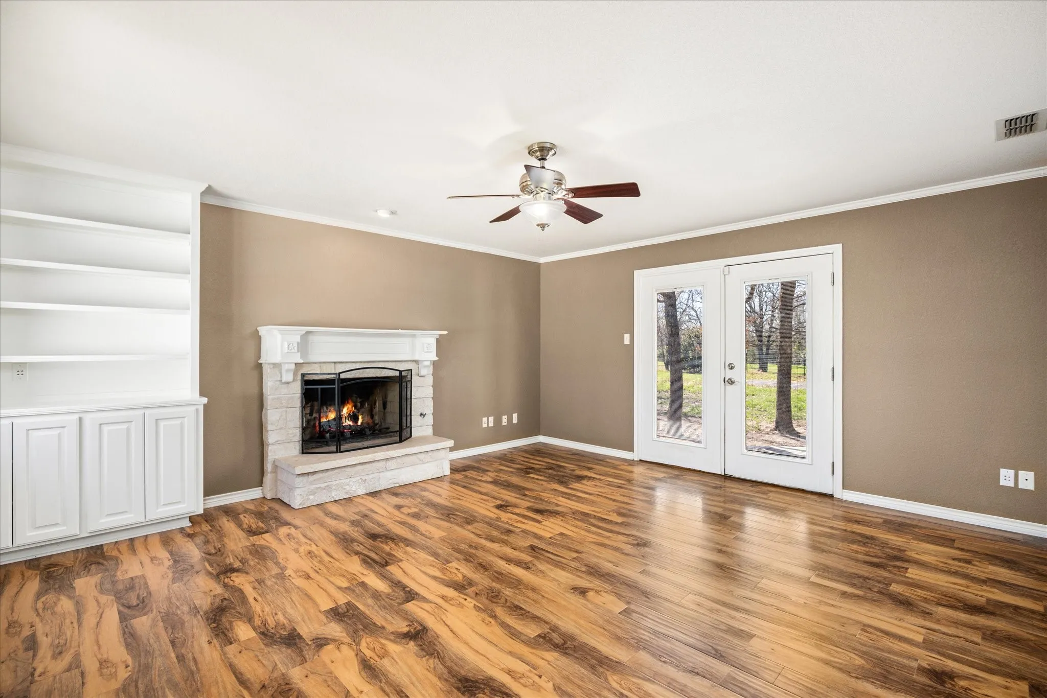 This room is the Den it's in the rear of thehouse also has a gas fireplace and built ins.  Also has double doors leading to an outside open rock patio.