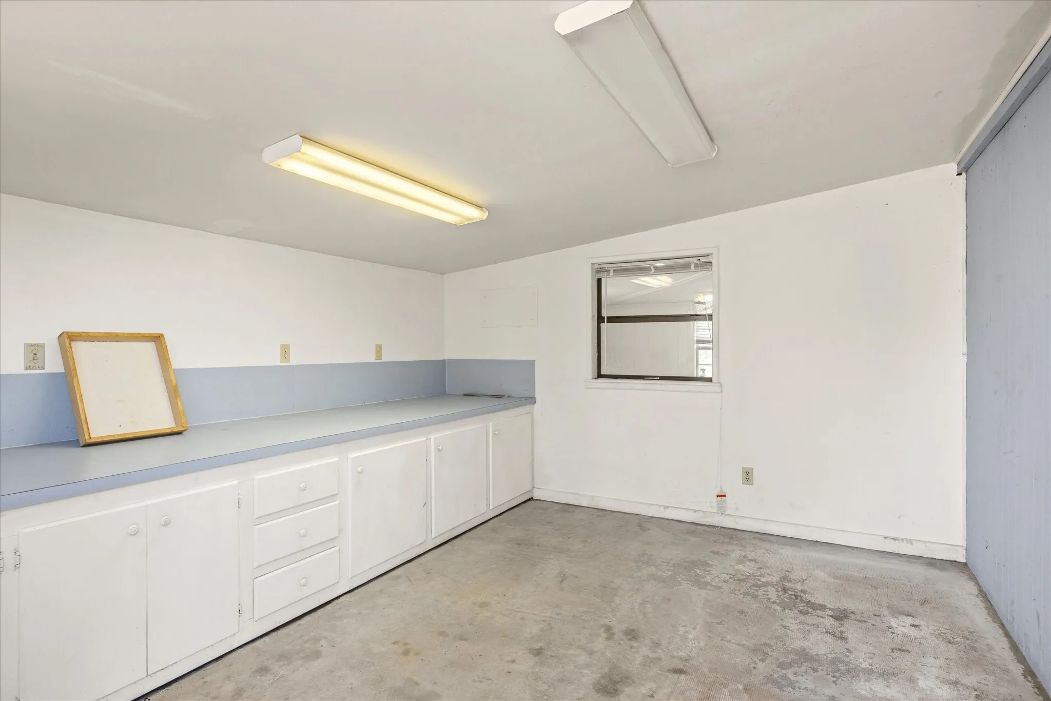 This would make a wonderful grooming place for dogs or a craft room.