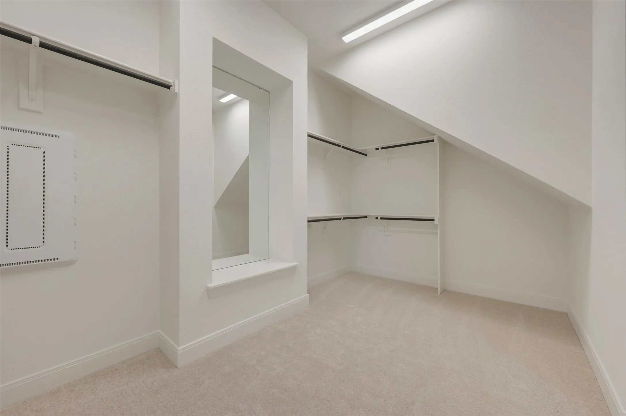 Spacious walk-in closet featuring built-in shelving, hanging rods, an integrated mirror, recessed lighting, and neutral carpeting