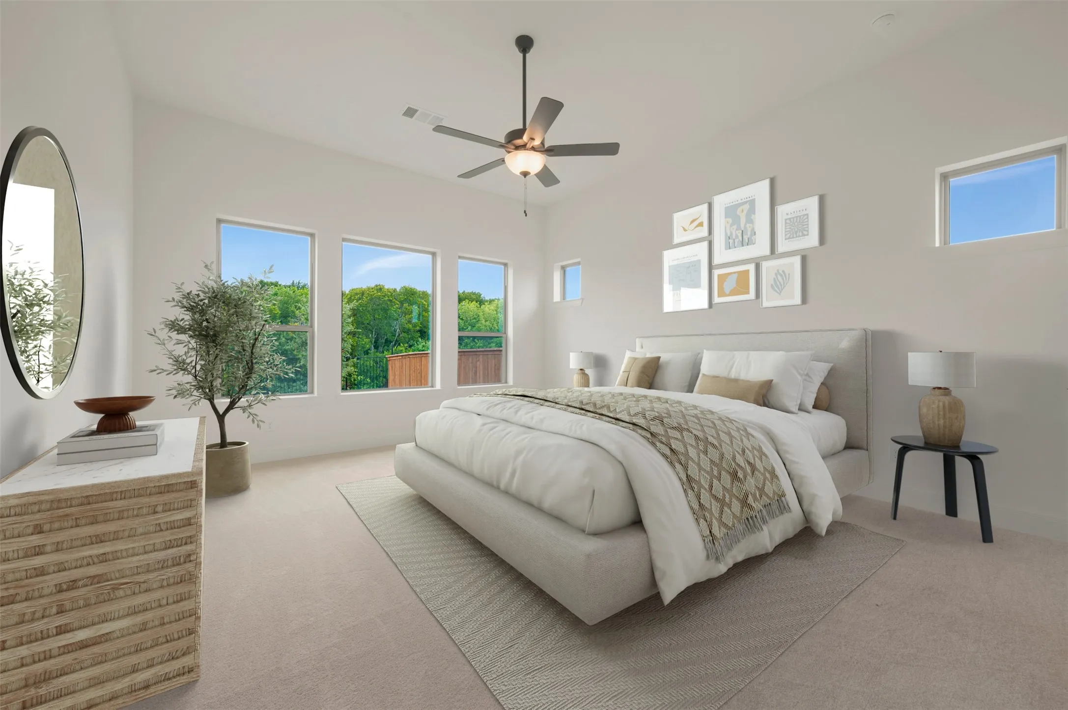 Spacious room featuring vaulted ceilings, plush carpeting, multiple windows, and a built-in ceiling fan