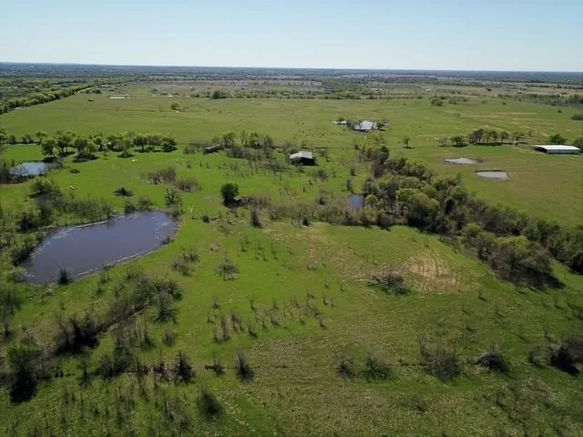 Aerial view of sparsely populated area featuring a nearby body of water