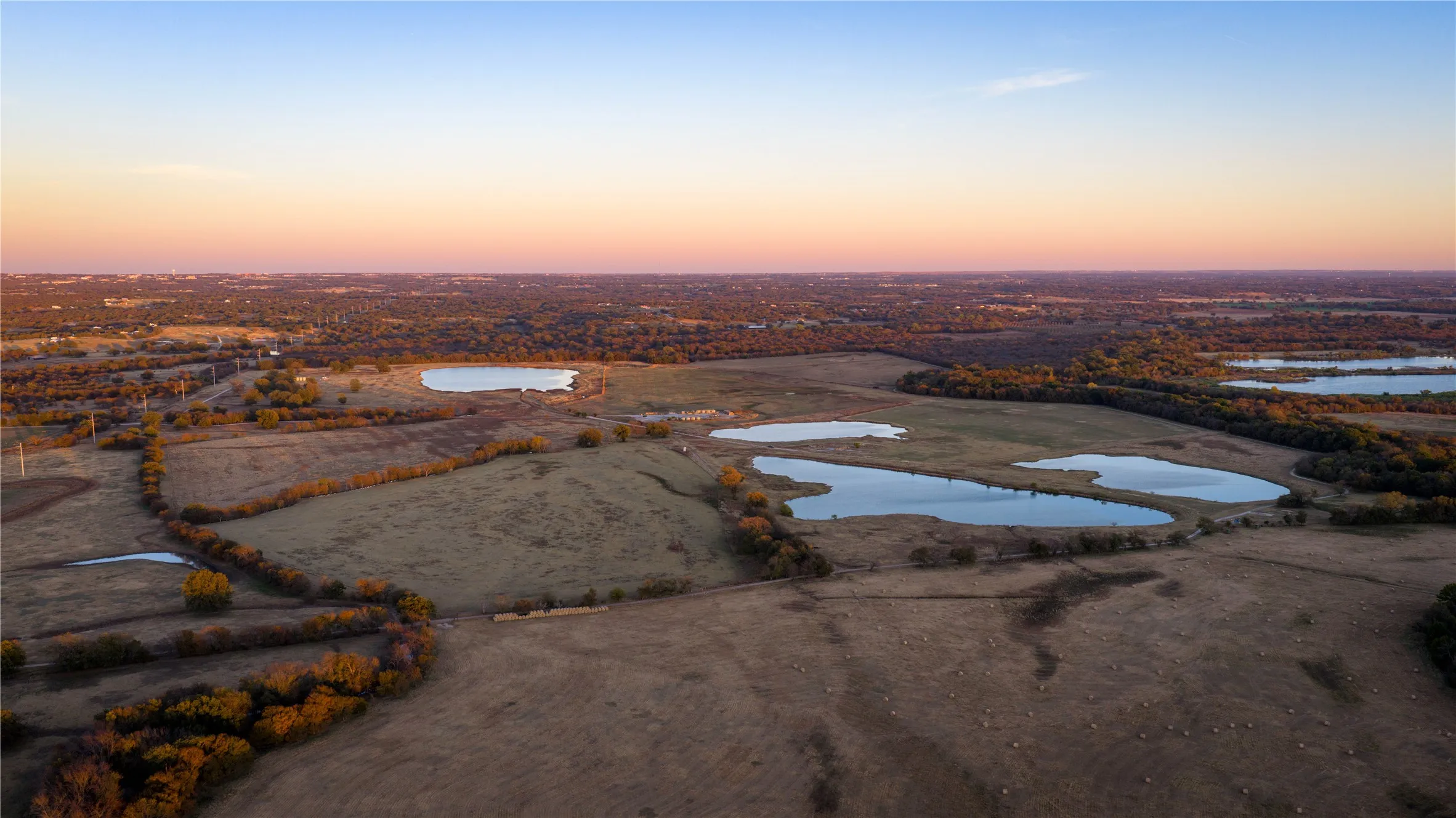 Elevated aerial showing multiple ponds and surrounding acreage.