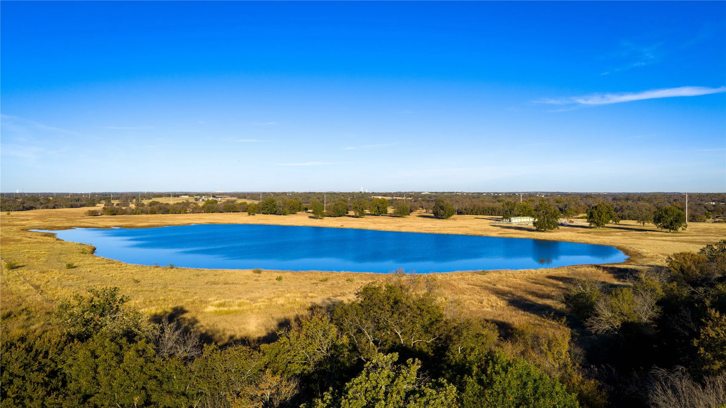 Large stocked pond with open pasture views.