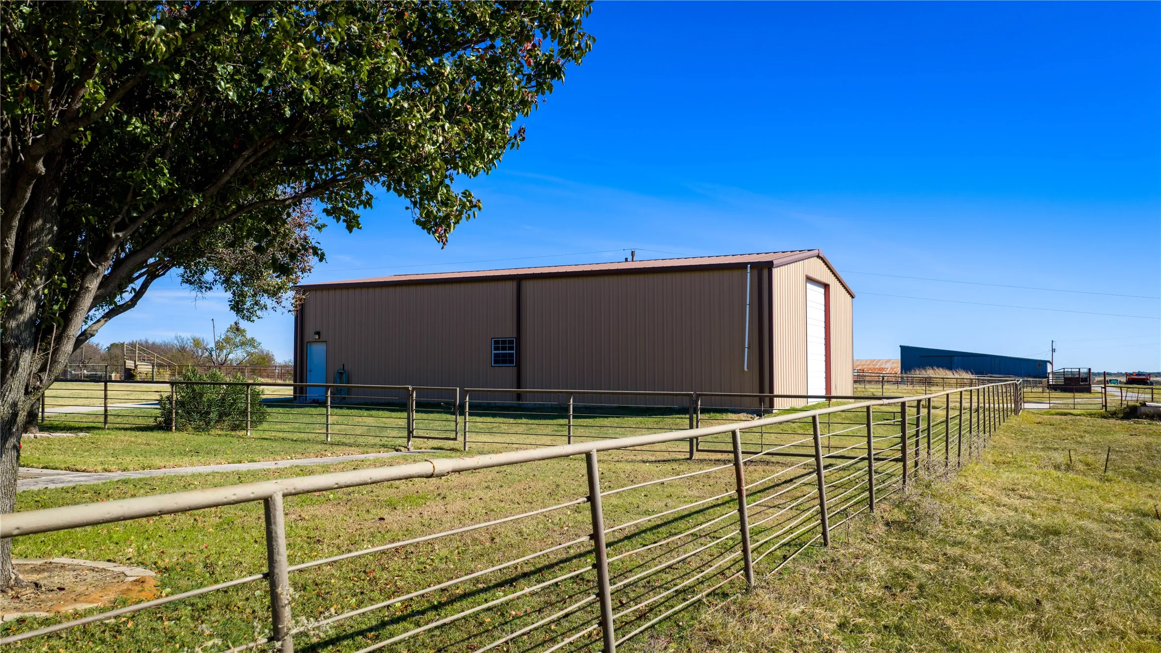 Large metal barn providing equipment and storage space.
