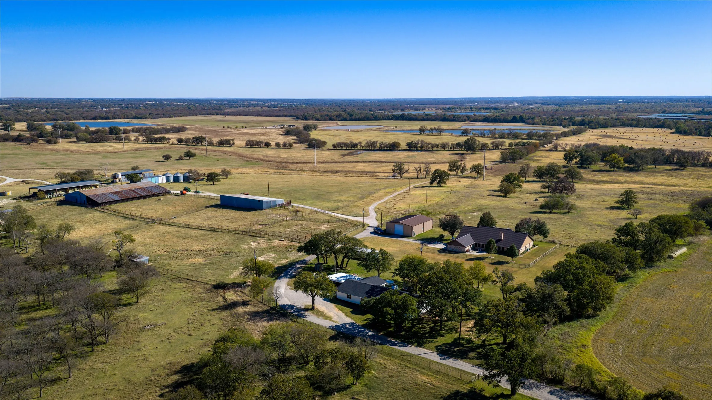 Overhead view showing homes, barns, and open acreage.