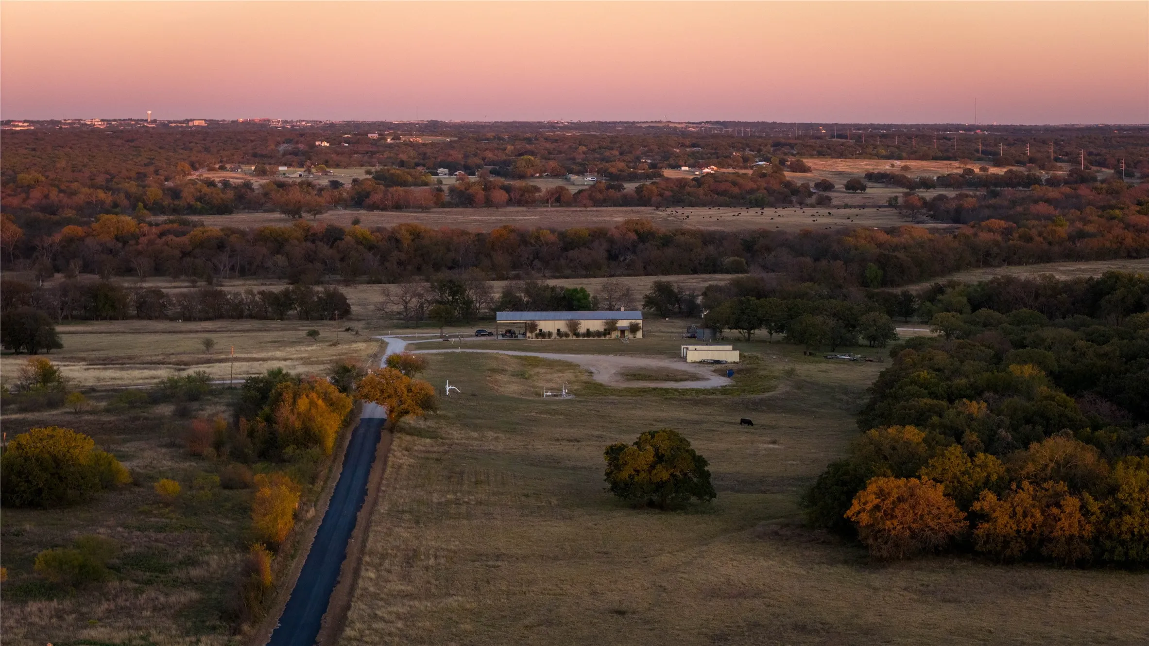 Aerial view of surrounding ranchland and neighboring properties.