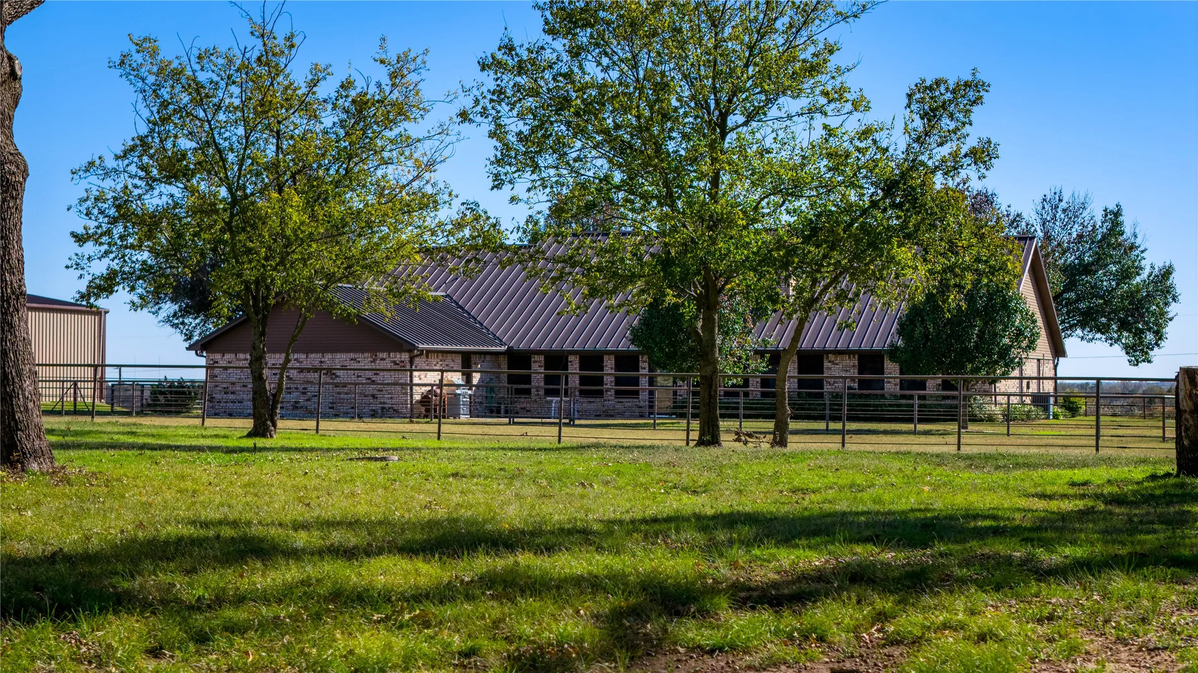 Expansive yard with mature shade trees surrounding the home.