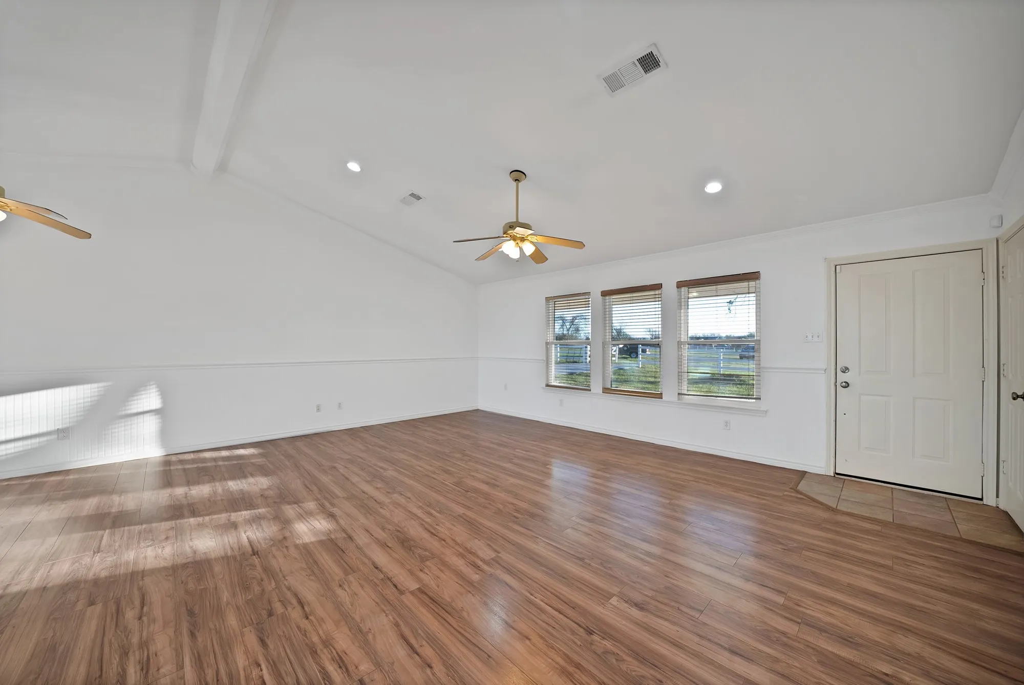 Unfurnished living room with ceiling fan, recessed lighting, dark wood-type flooring, and lofted ceiling with beams