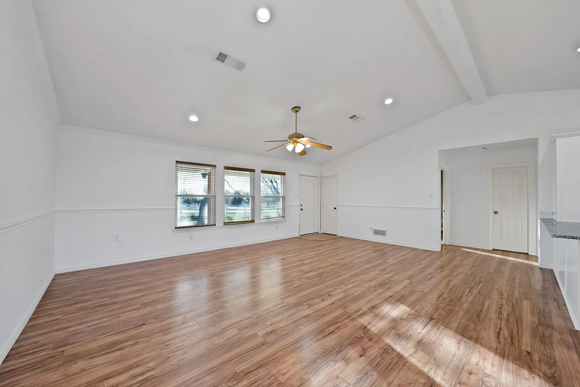 Unfurnished living room featuring recessed lighting, light wood finished floors, a ceiling fan, and beam ceiling
