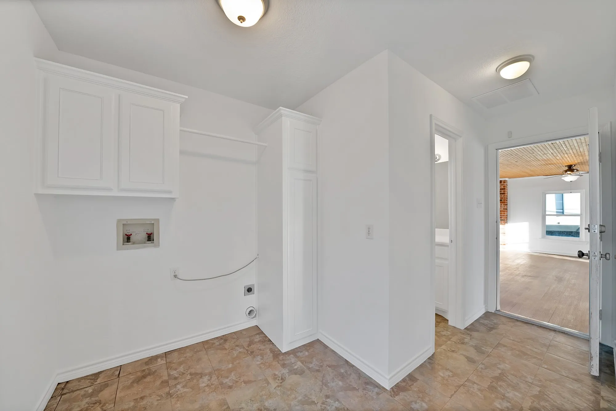 Laundry area featuring hookup for a washing machine, hookup for an electric dryer, and cabinet space