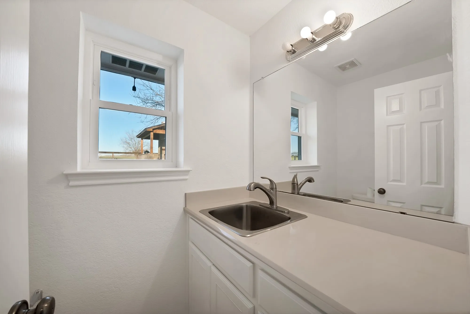 Bathroom with plenty of natural light and vanity