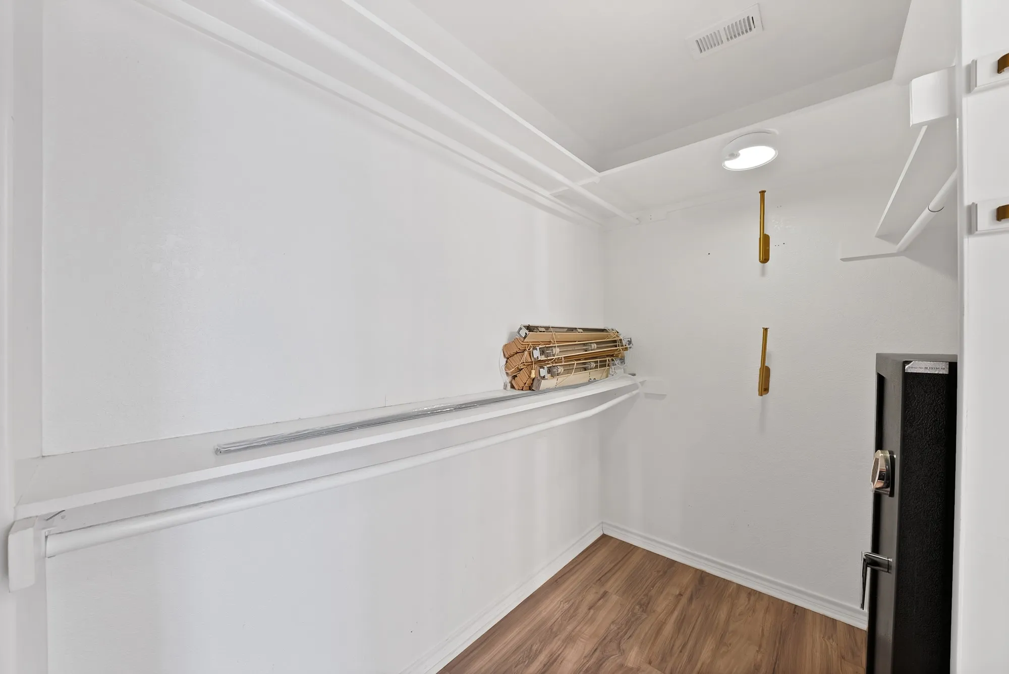 Walk in closet featuring dark wood-style flooring