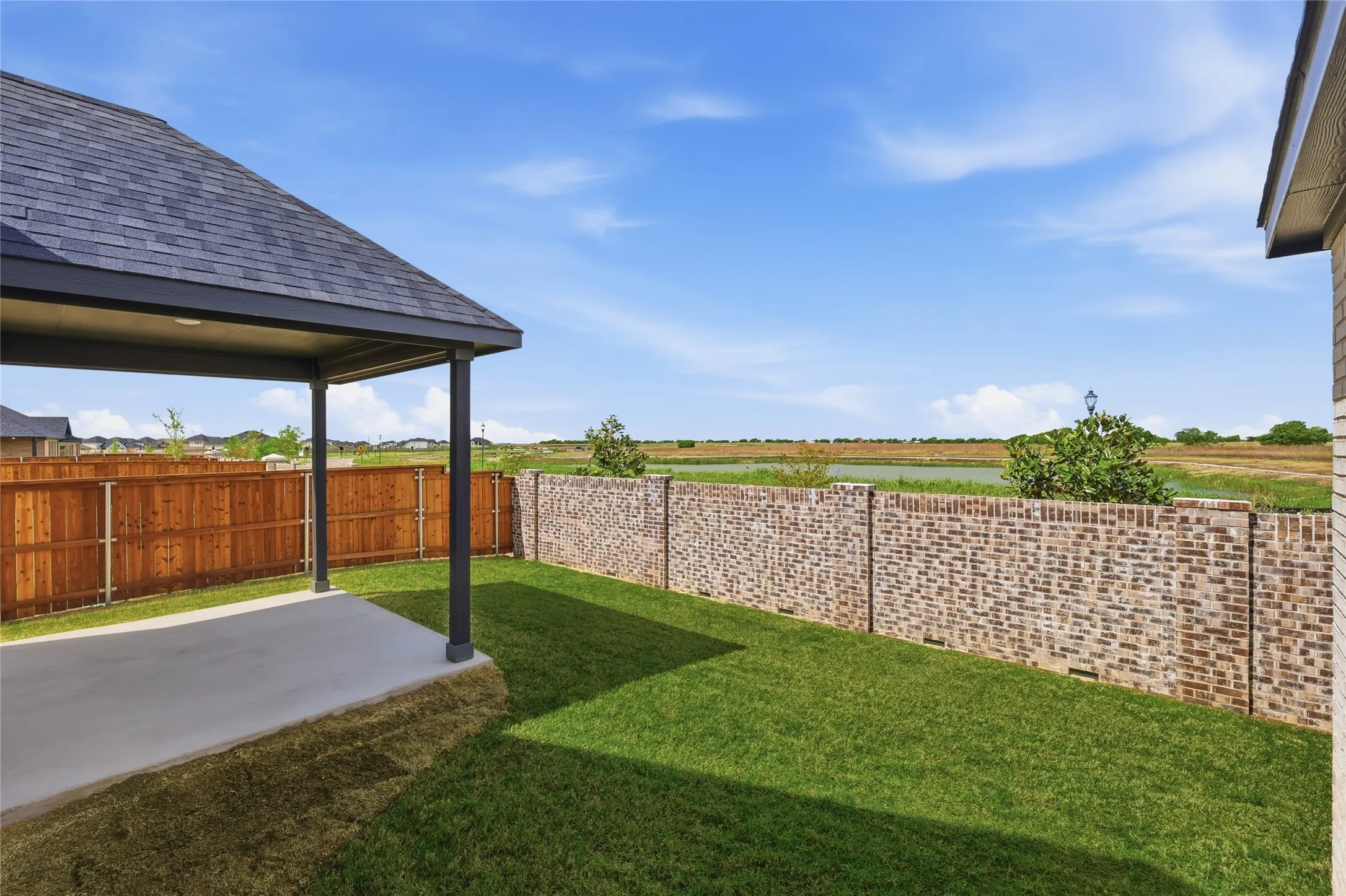 Fenced backyard with a patio area
