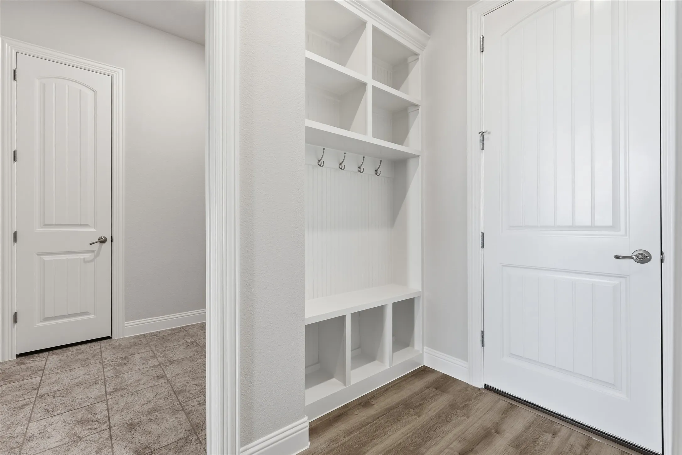 Mudroom featuring baseboards and light wood-style flooring