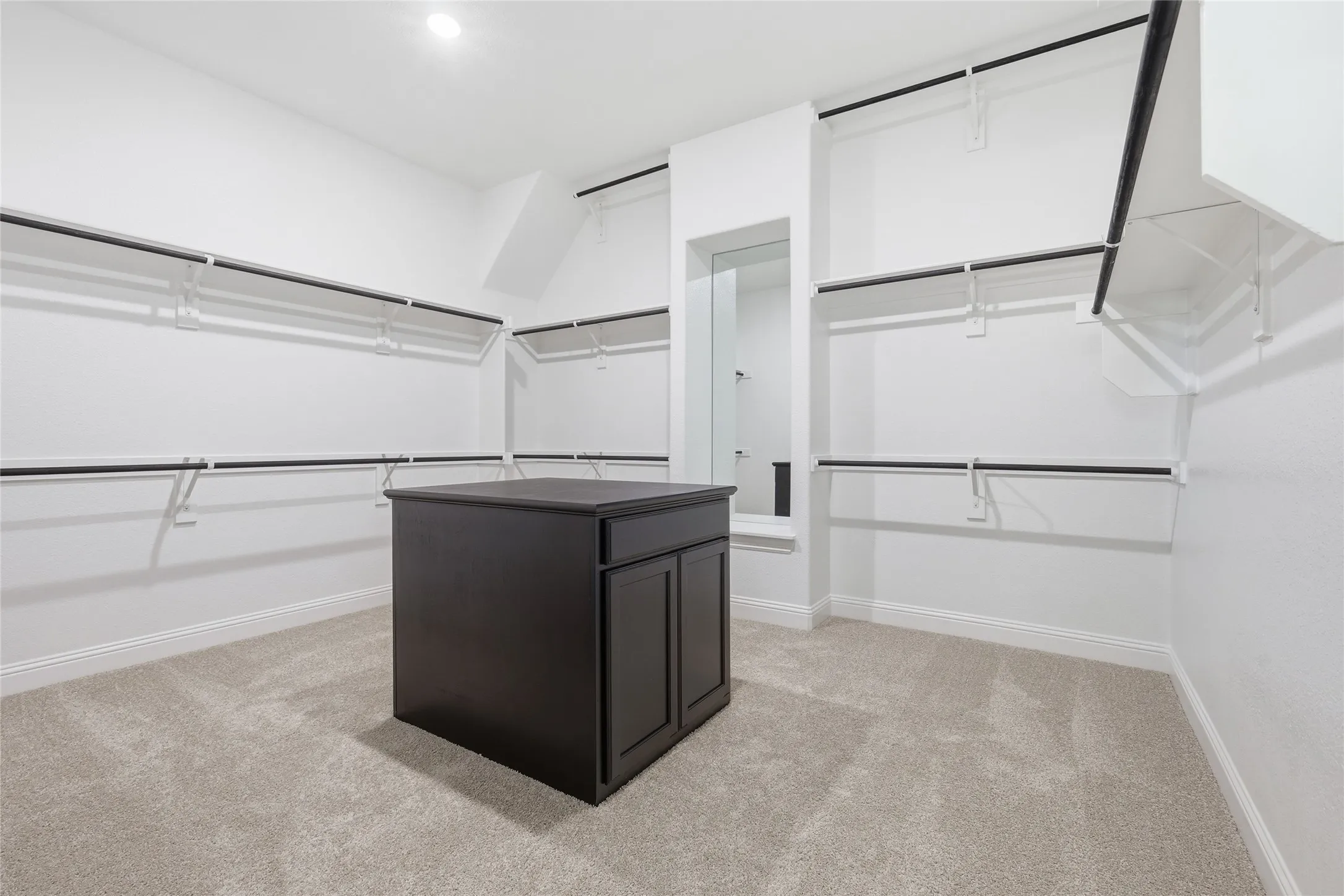 Walk in closet featuring light carpet