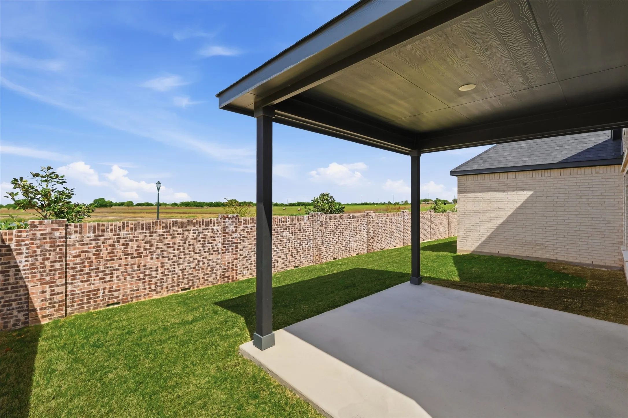 Fenced backyard featuring a patio