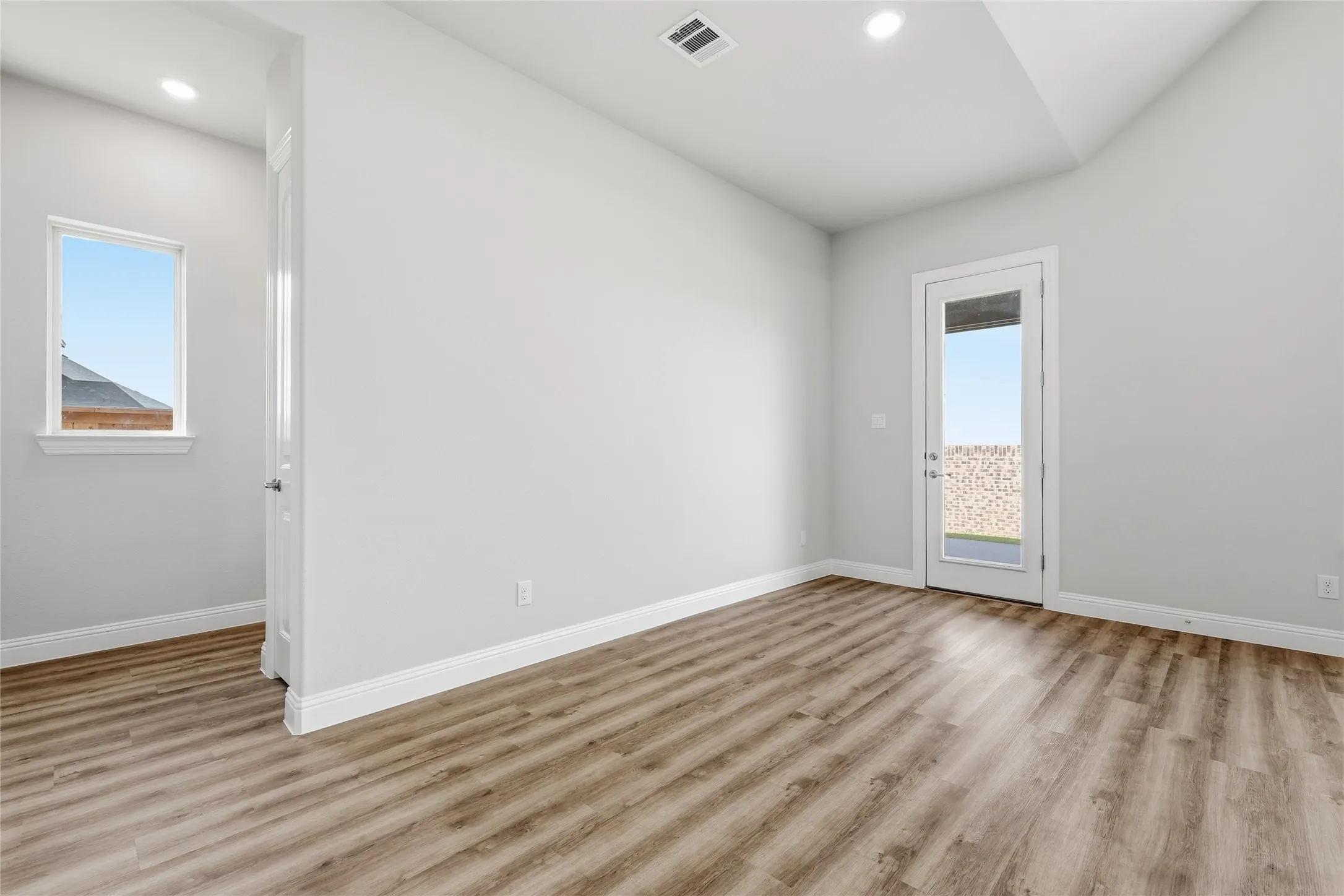 Unfurnished room with light wood-type flooring and recessed lighting