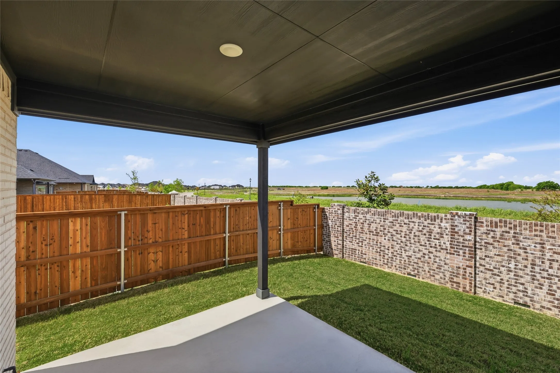 Fenced backyard with a patio area