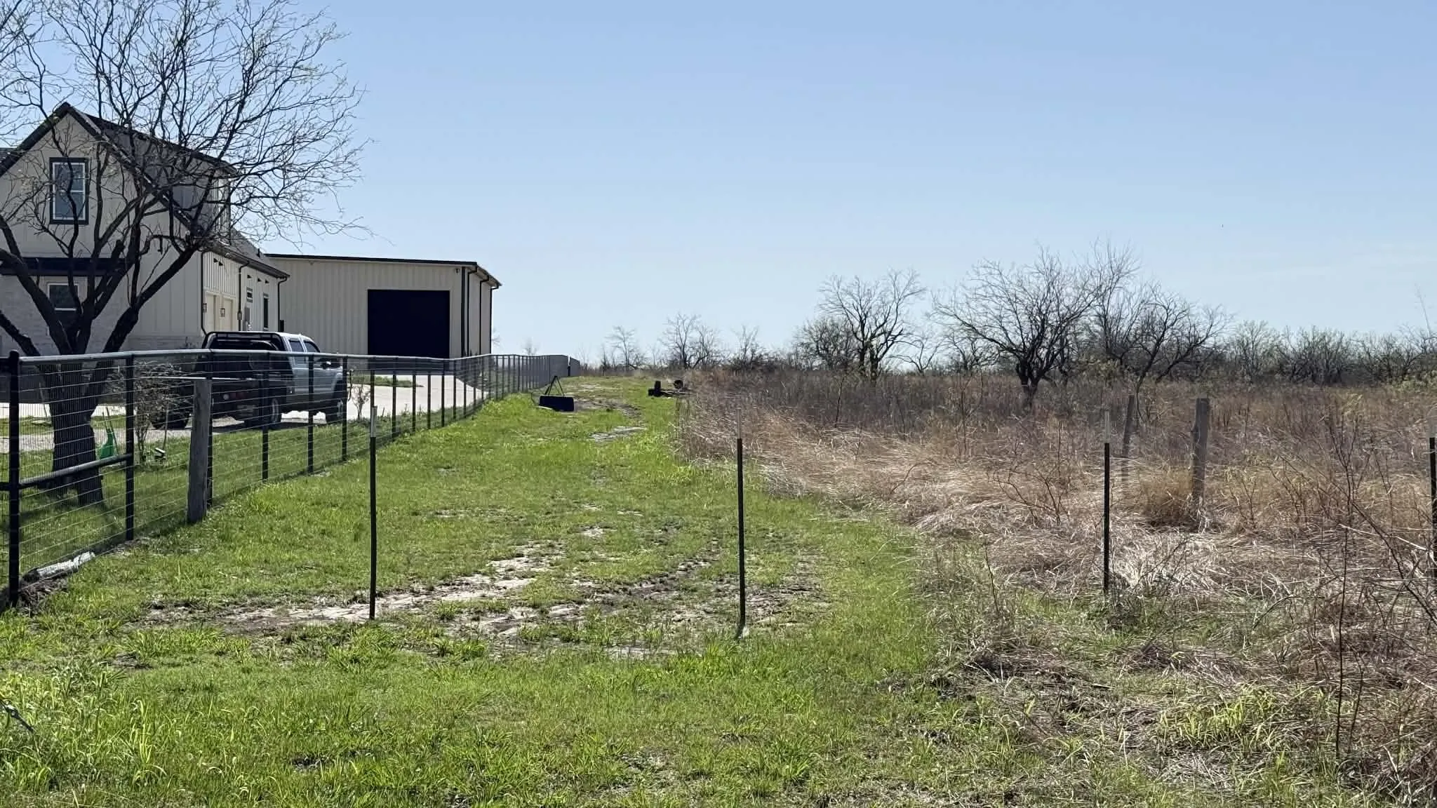 View of yard featuring a view of countryside, an outbuilding, and a detached garage