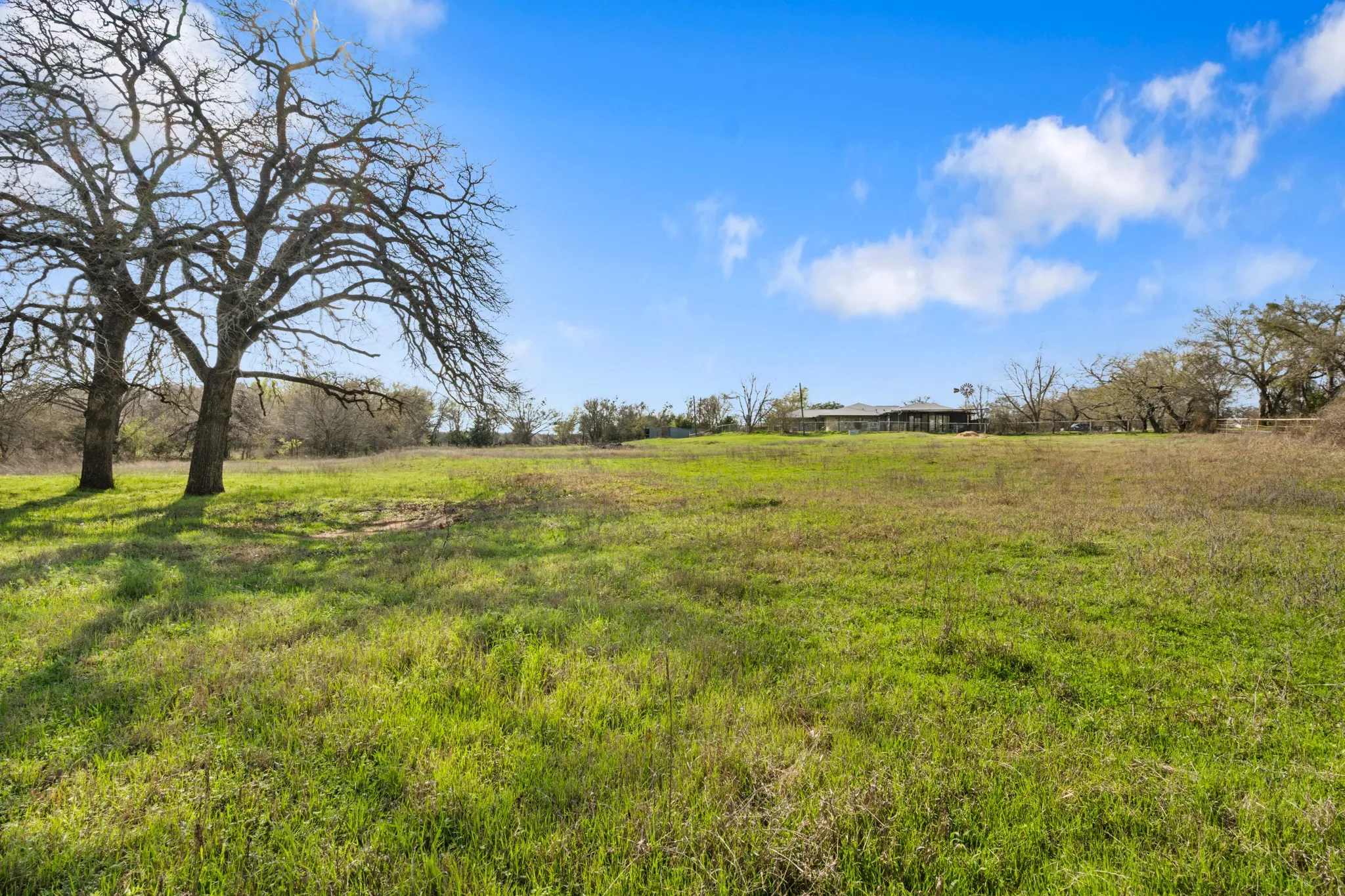 View of green lawn with a view of countryside