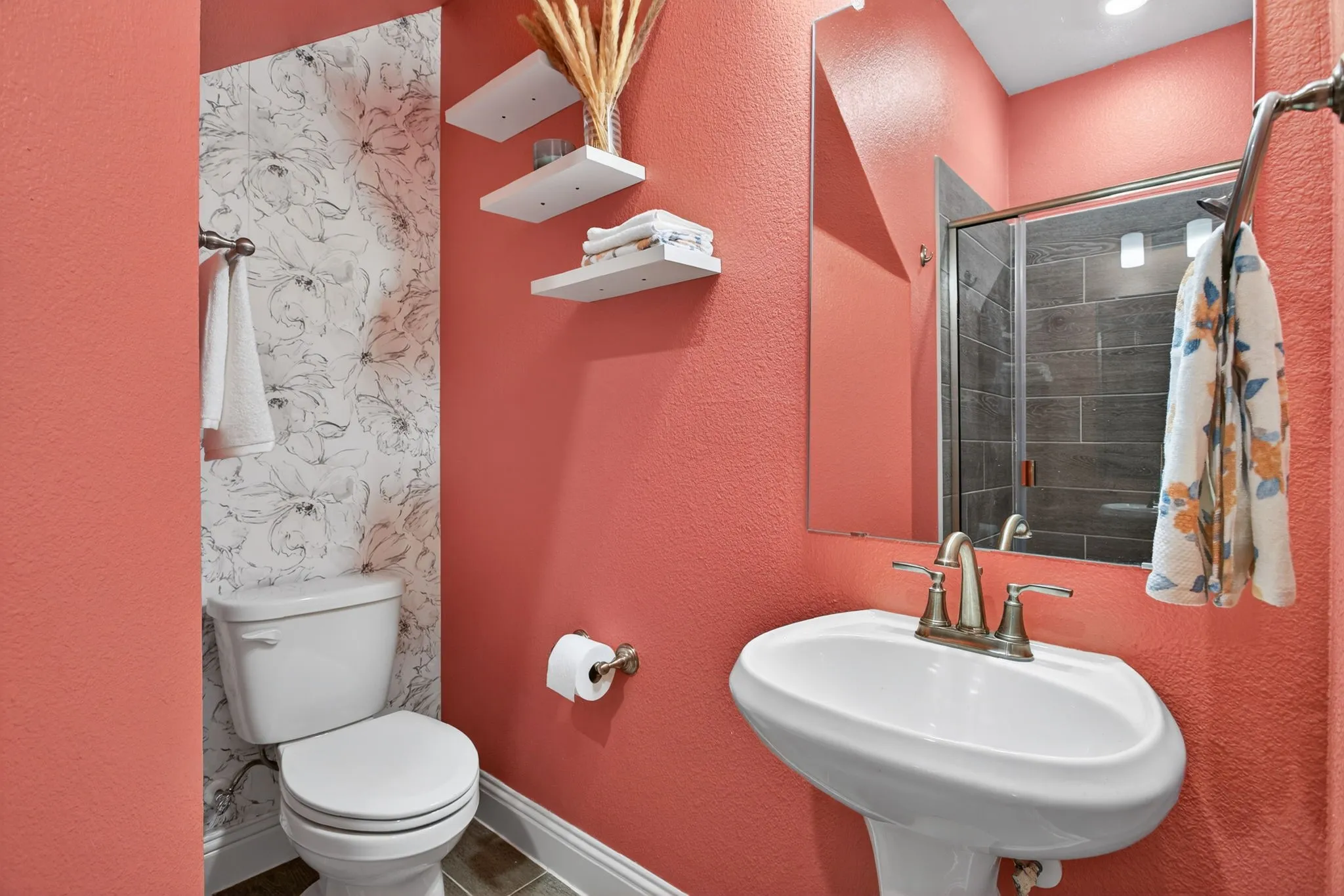 In the hall at the front of the home is the downstairs FULL bathroom. FUN color - shower, toilet and sink!