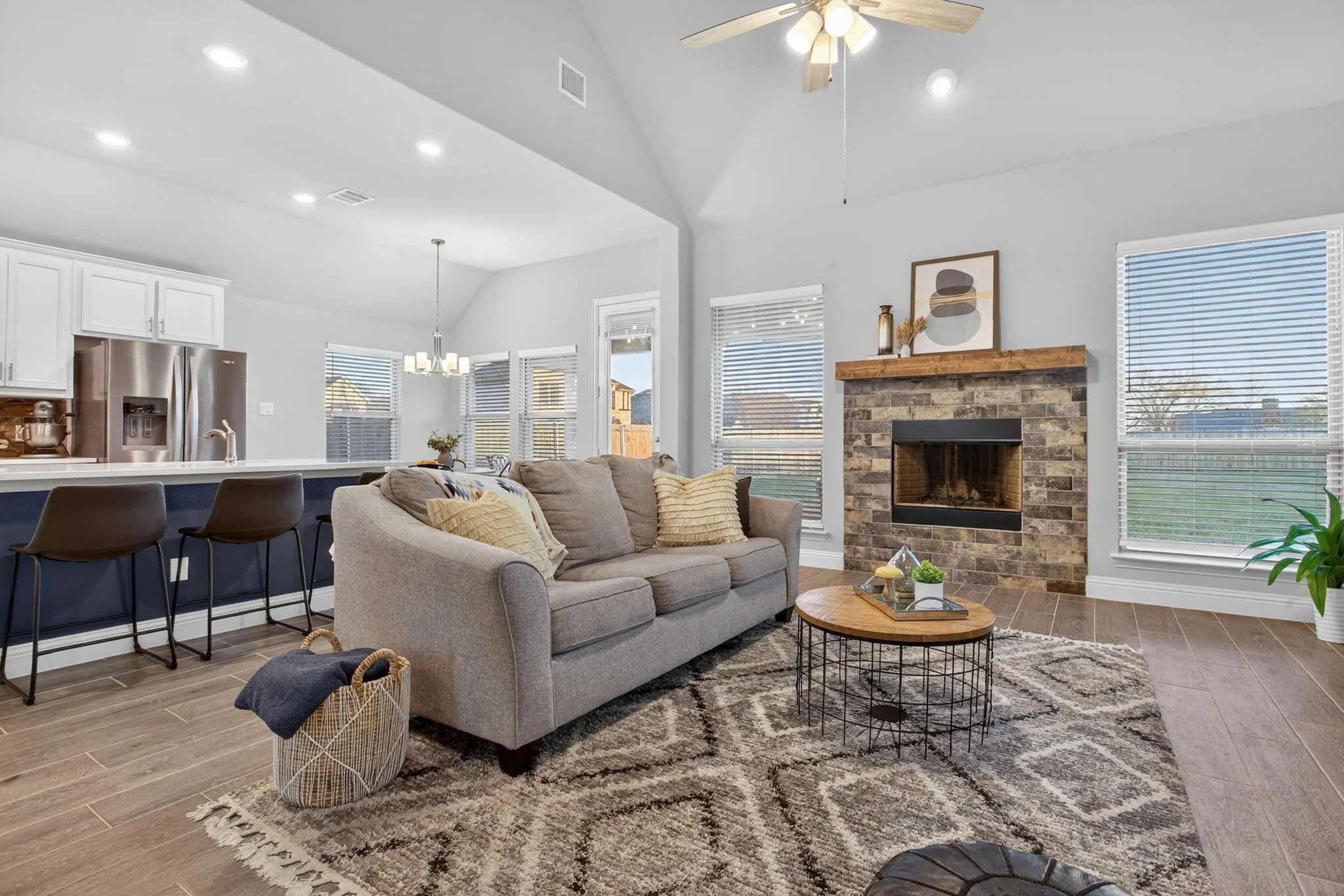 The open concept feels spacious and washed with natural light; views to the HUGE backyard.