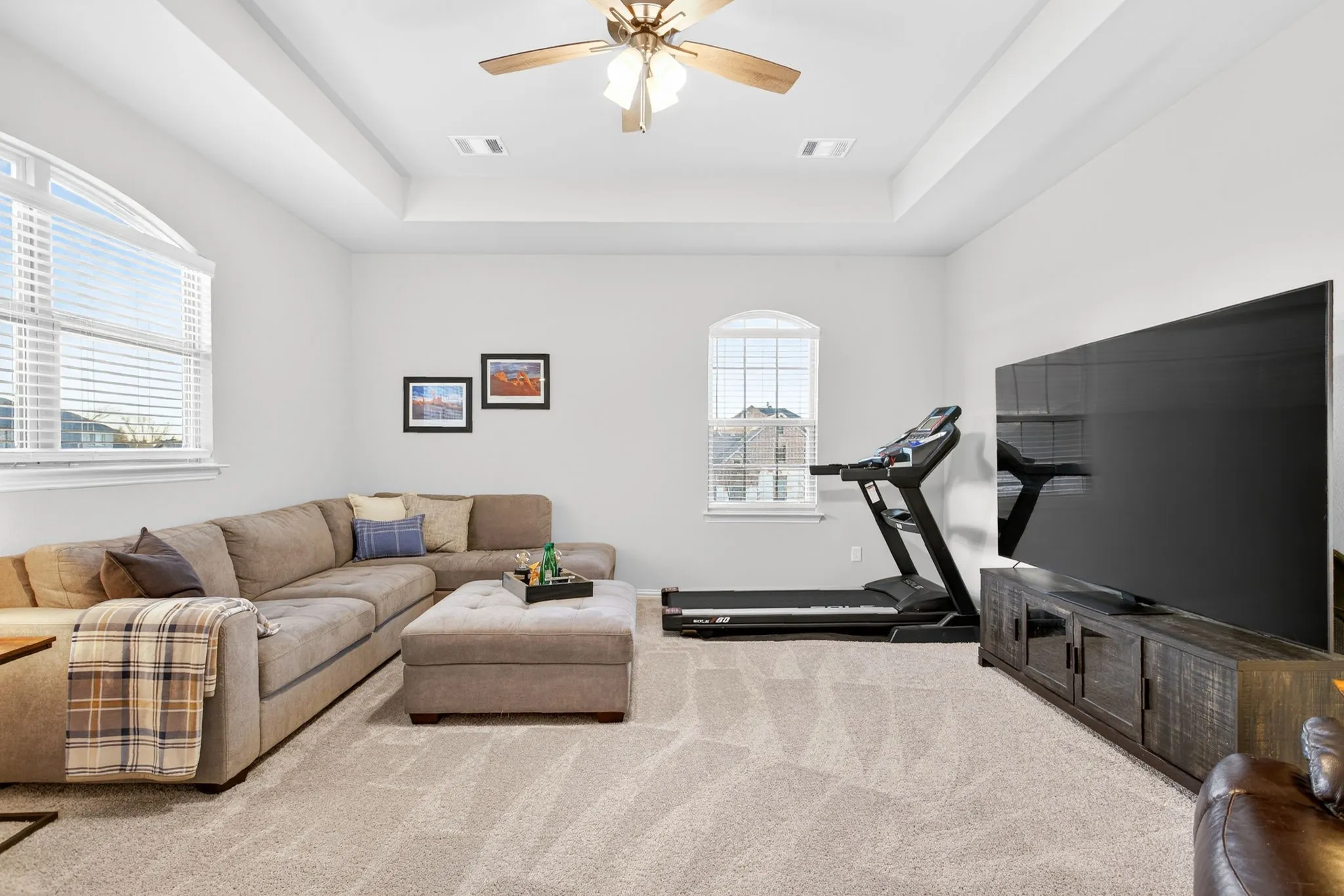 Step down into this space with big windows and a tray ceiling.