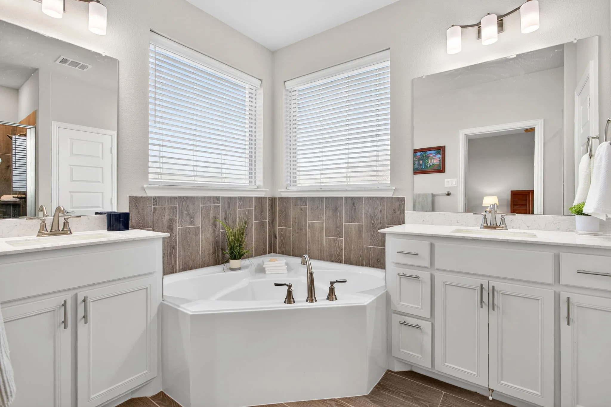 Split vanities flanking the soaking tub. Yes, please!