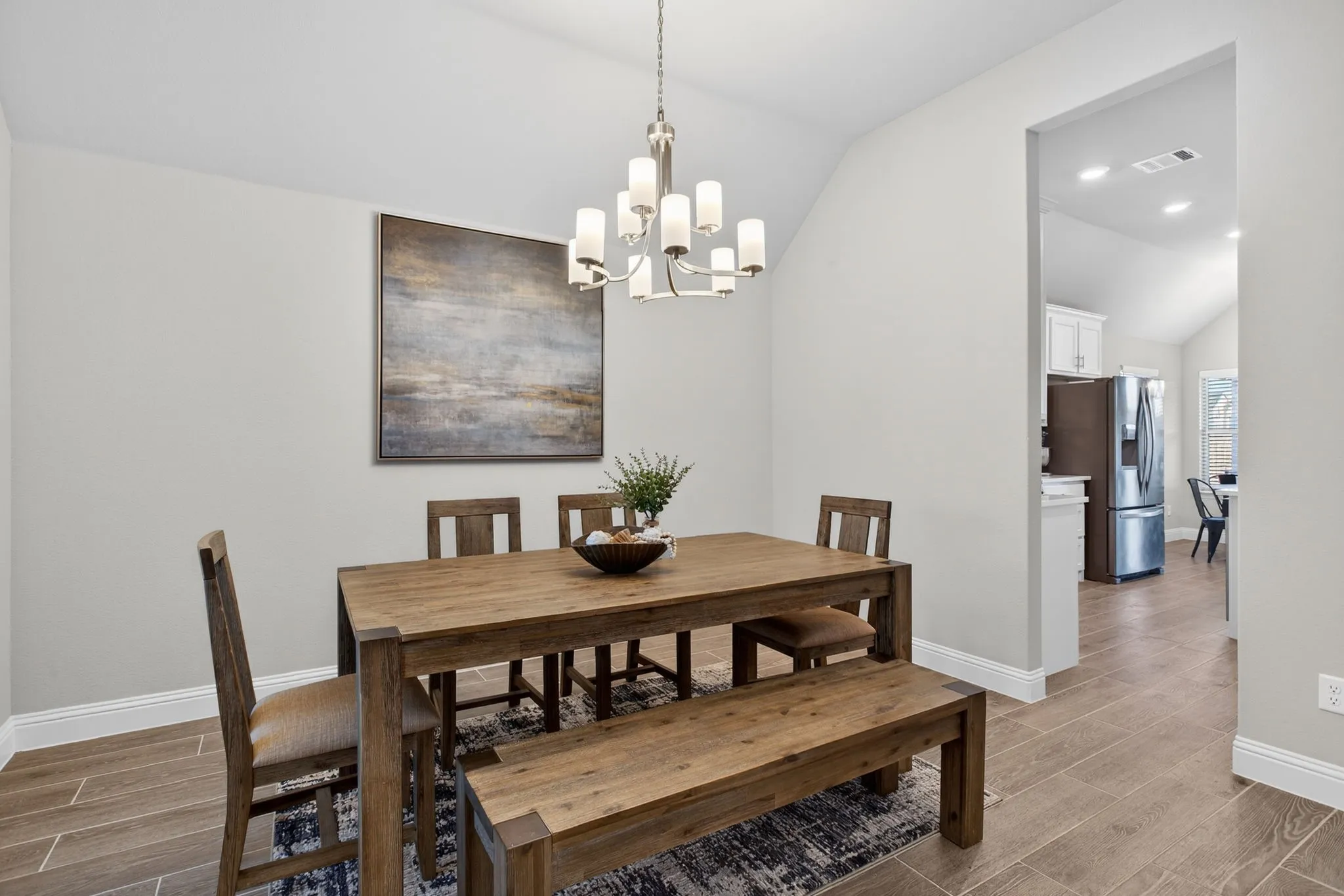 Tall ceilings and tall baseboards. Dining connects to the kitchen.
