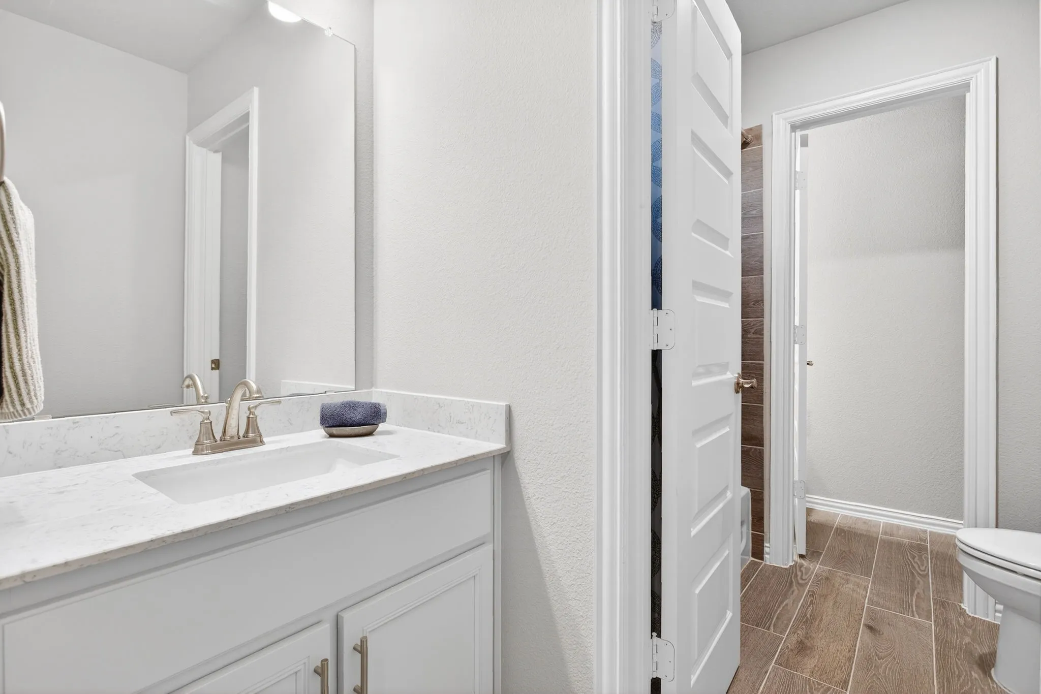 Connects to a classic Jack and Jill bathroom with vanities separated by the shower and toilet.