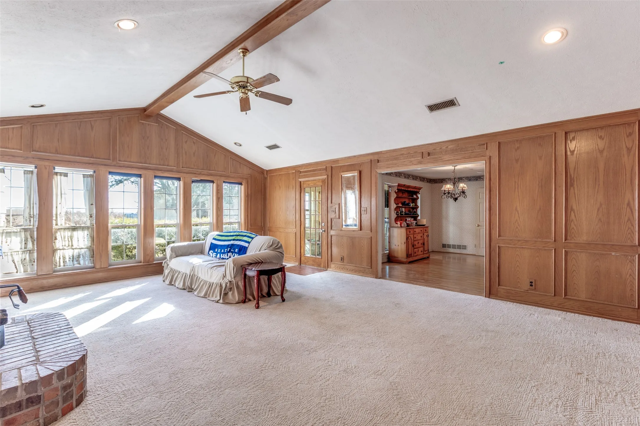 Living room with access to kitchen and sunroom.