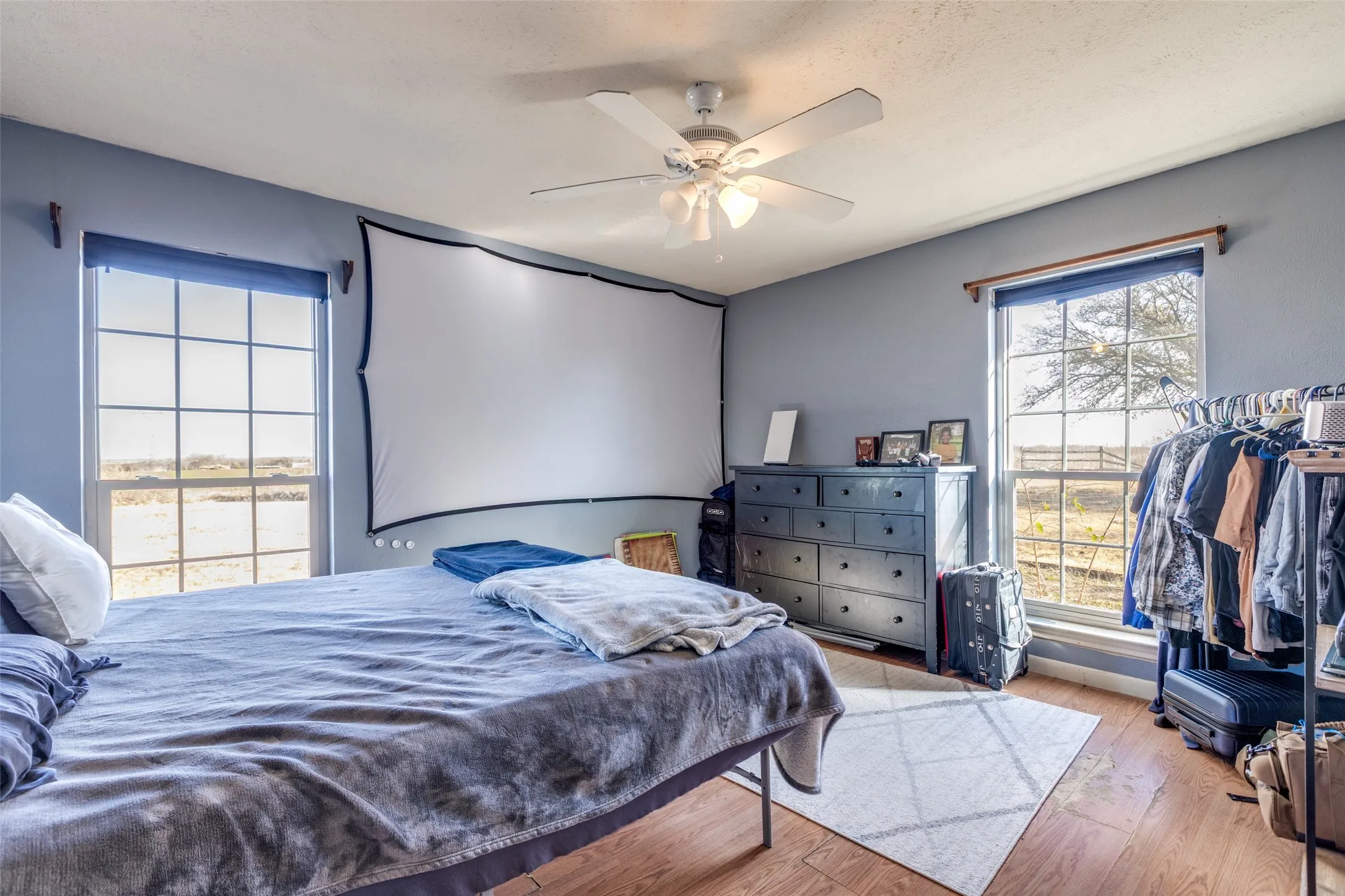 Bedroom with wood finished floors and ceiling fan