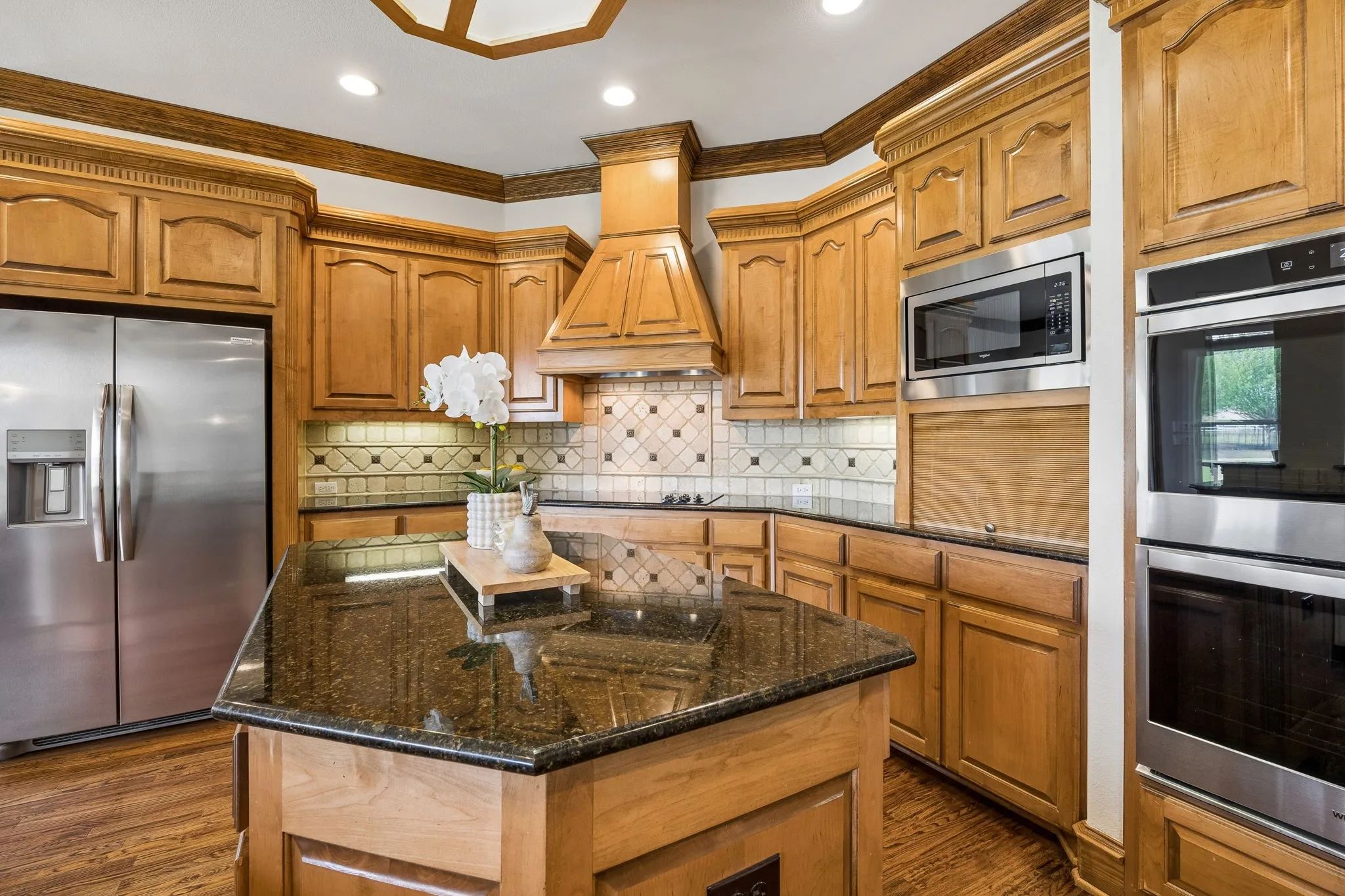 Double ovens and large island in this chefs kitchen