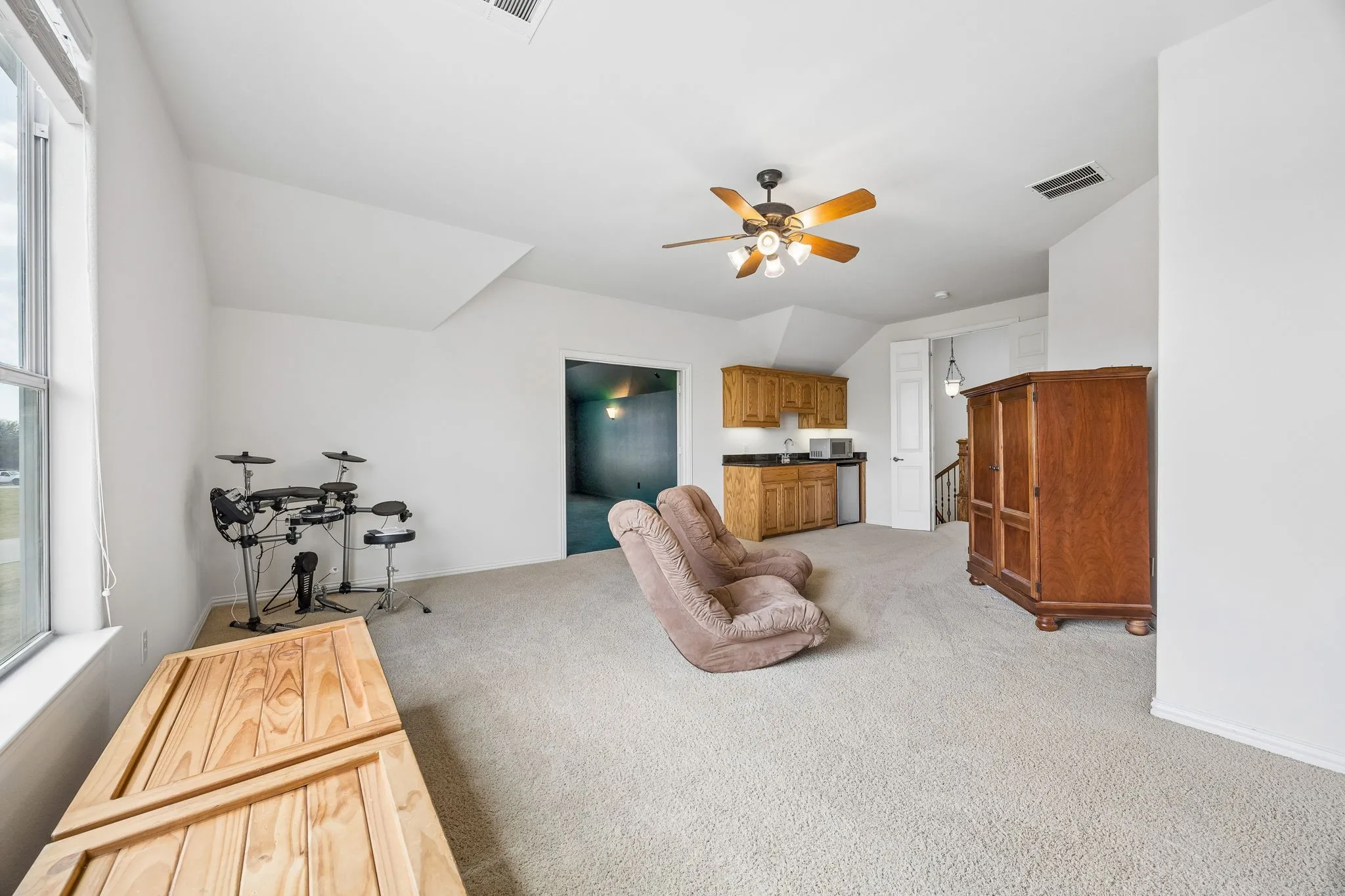 Game room with kitchenette opening to the media room