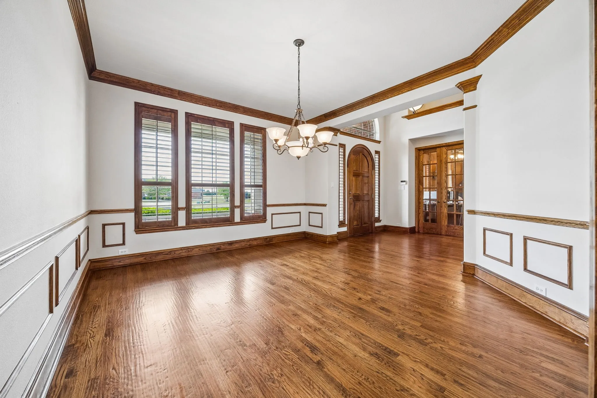 Dining room with wood floors and shutters