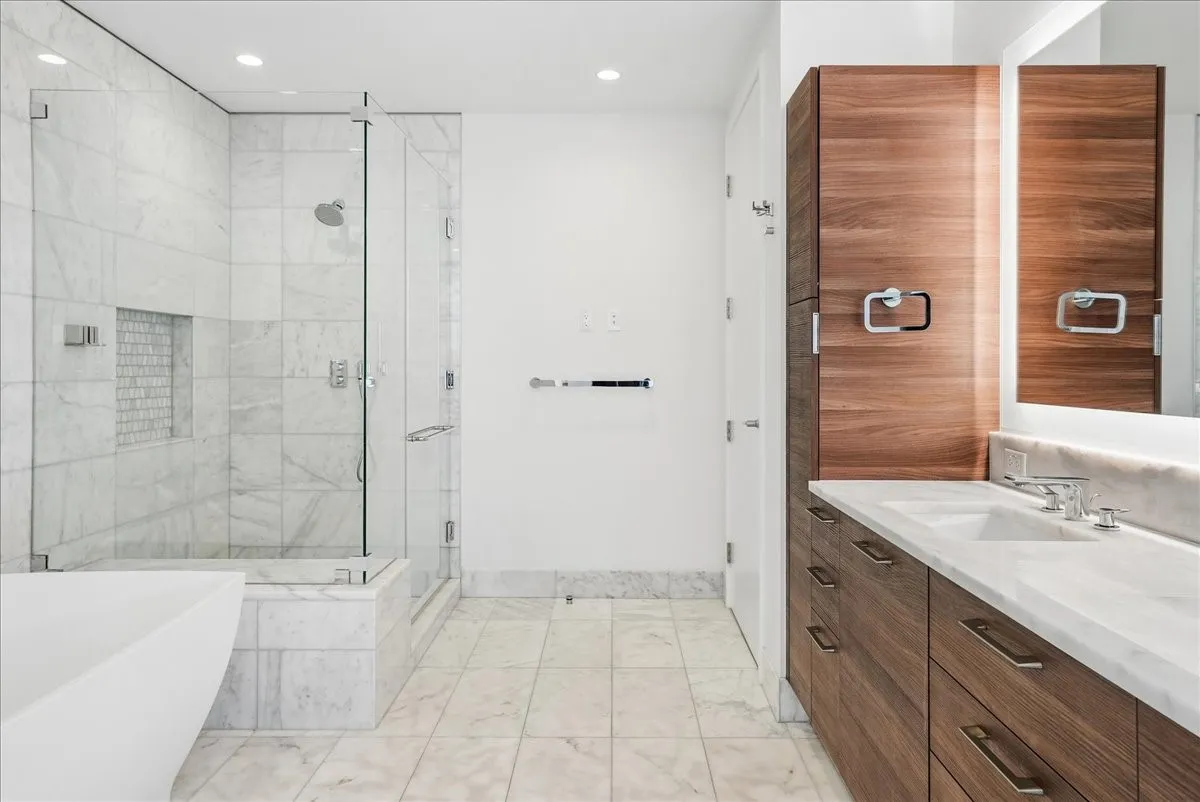 Spacious en suite primary bath with soaking tub and oversized walk-in shower