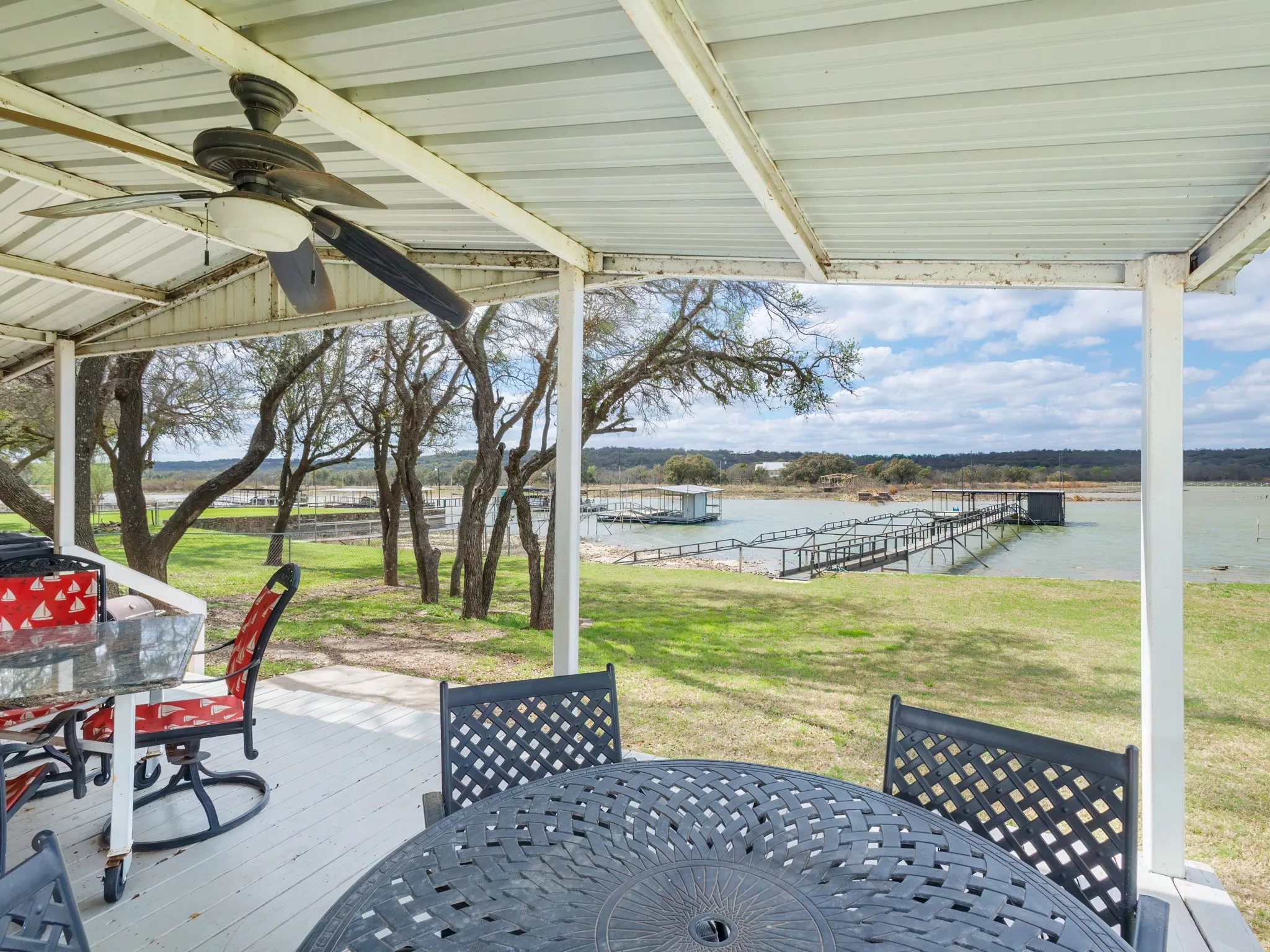 View of patio / terrace featuring outdoor dining space, a water view, and a ceiling fan